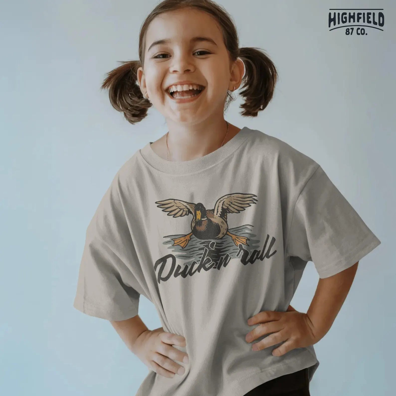 A mallard duck descending fast towards water, feet first, with a rock 'n roll pun – “Duck 'n Roll.” Great for humorous hunting apparel and merch printing.