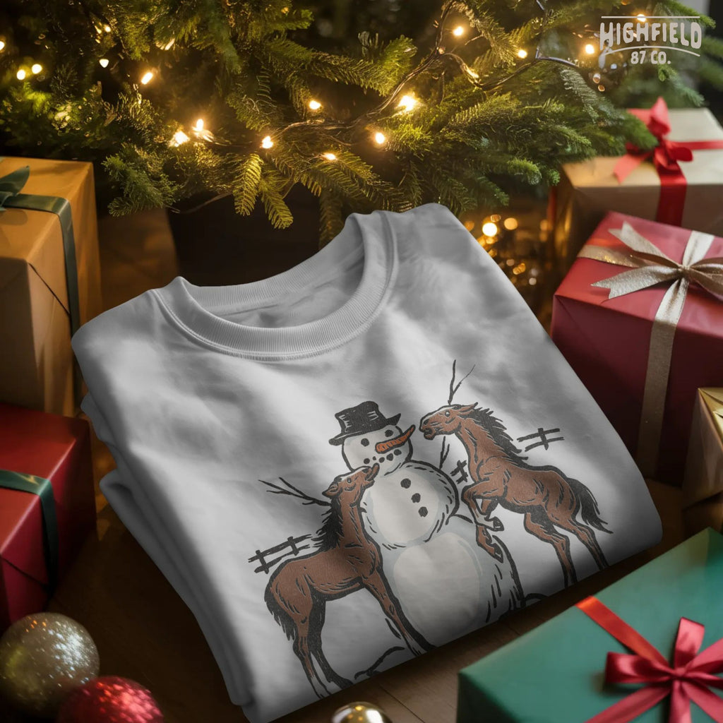 Winter horse PNG showing two brown horses around snowman, rustic countryside theme for farm Christmas crafts.