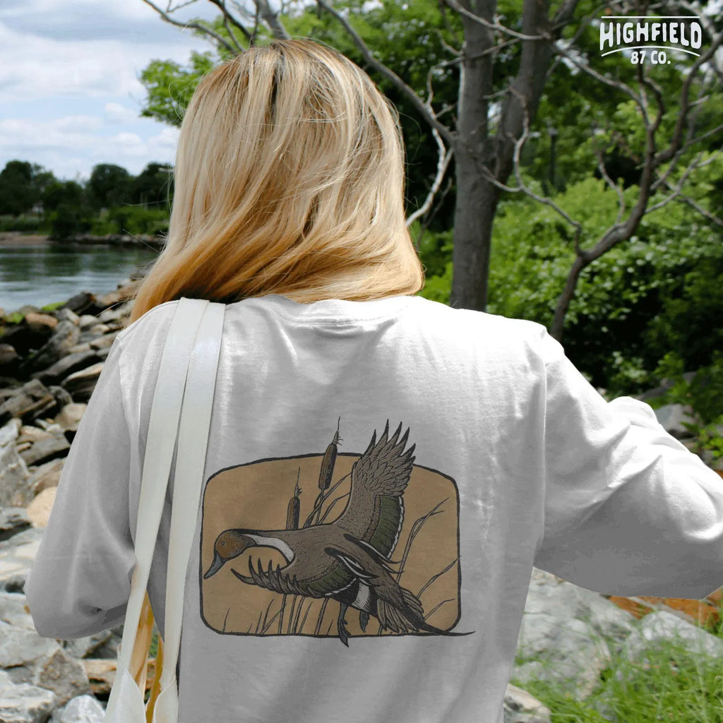 Northern pintail duck PNG with earthy tones and natural background, suitable for digital hunting clipart or wildfowl apparel art.