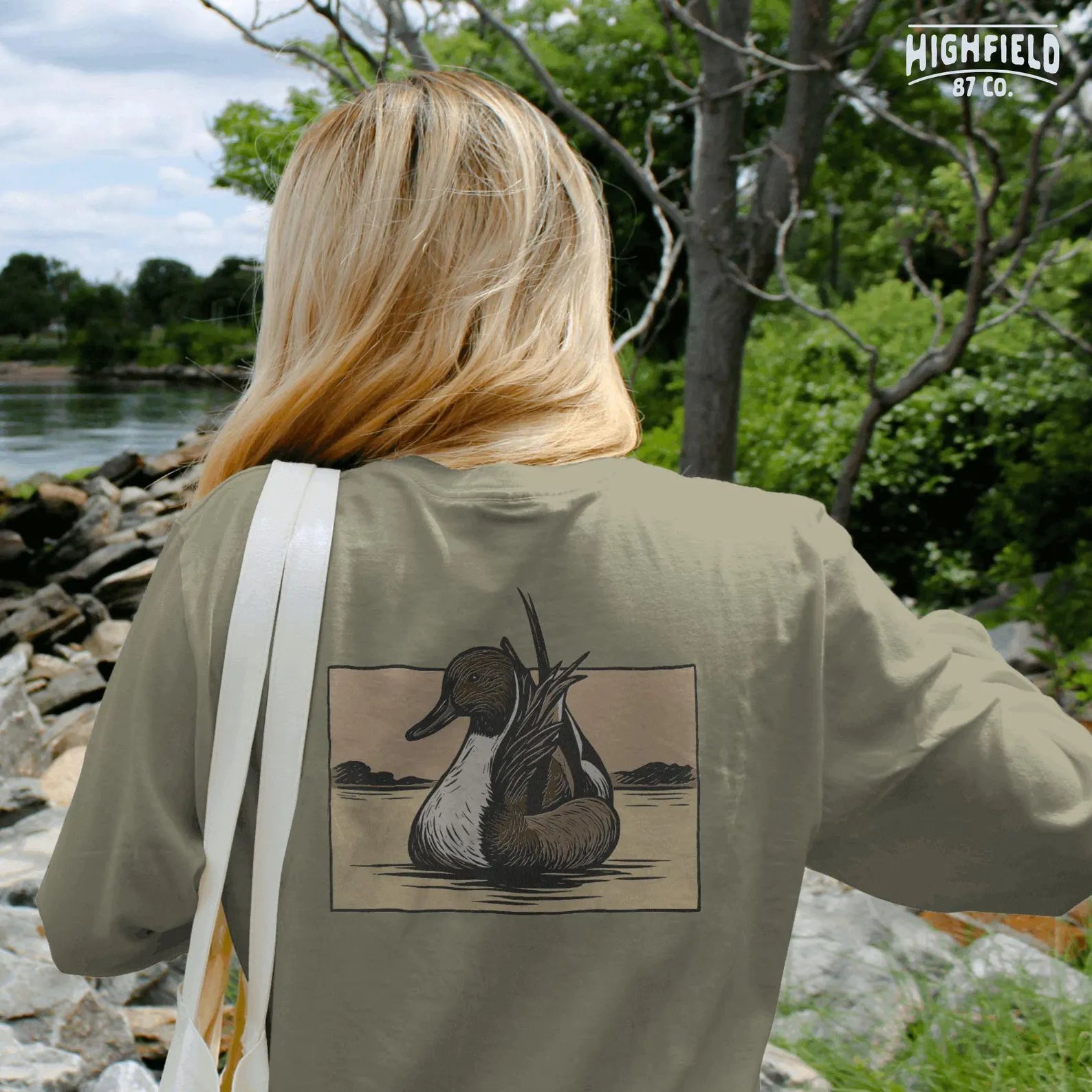 Pintail drake PNG artwork featuring duck resting on open lake, transparent background for sublimation and hunting apparel.