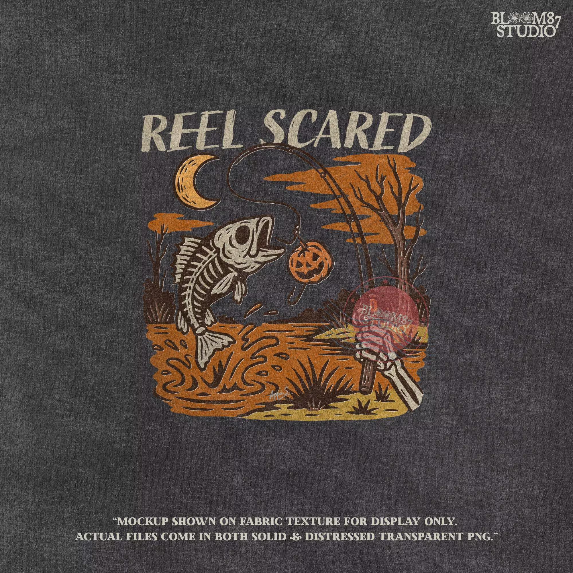 Dark gray t-shirt with 'Reel Scared' graphic design featuring a fish skeleton, pumpkin, and moon.