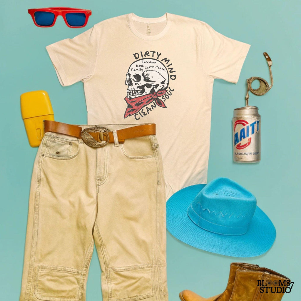 Vintage-style illustration of a cowboy skull wearing a red bandana, featuring handwritten words about freedom, family, and cattle. Perfect for western decor and apparel.