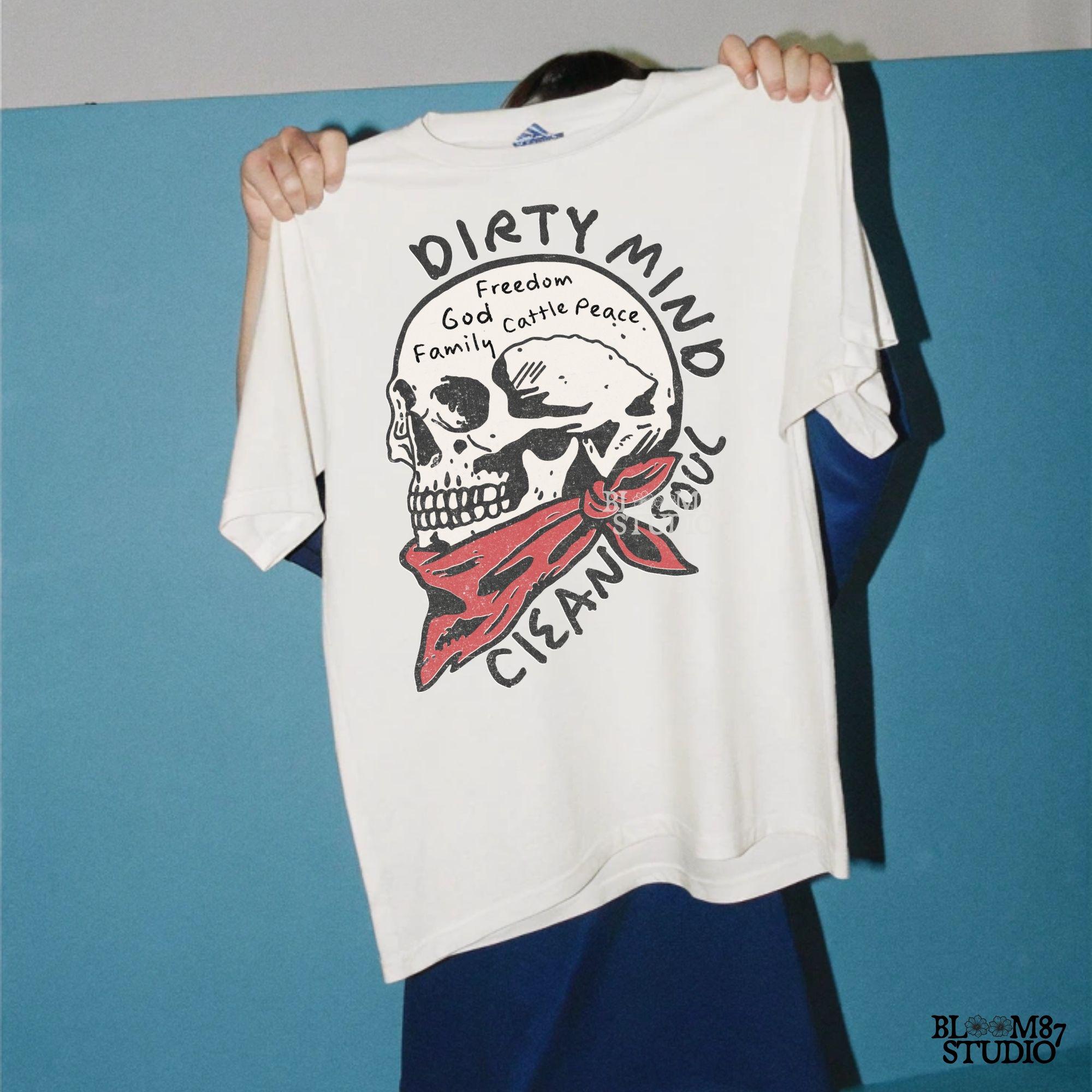 Vintage-style illustration of a cowboy skull wearing a red bandana, featuring handwritten words about freedom, family, and cattle. Perfect for western decor and apparel.