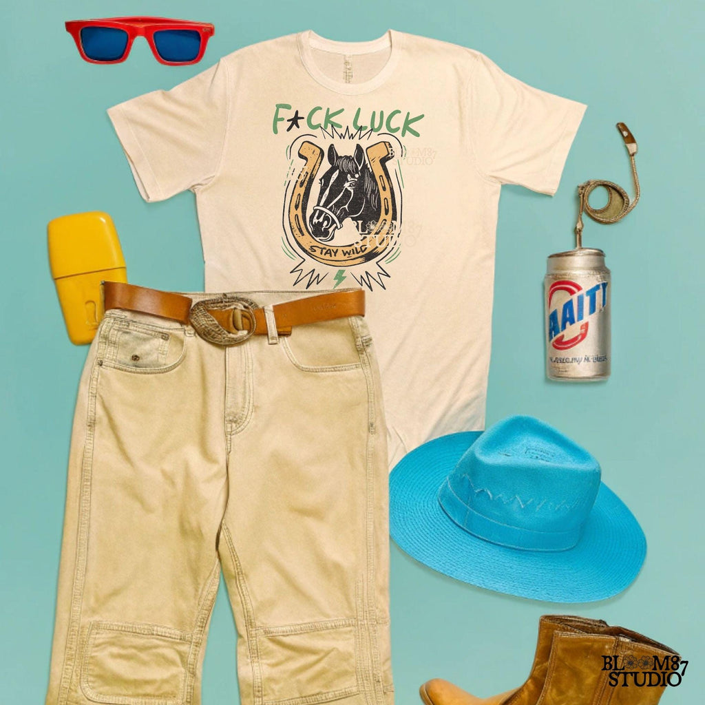 Vintage Western-style PNG featuring a horse inside a horseshoe with lightning bolts, the phrase “Stay Wild,” and an edgy rebellious message.