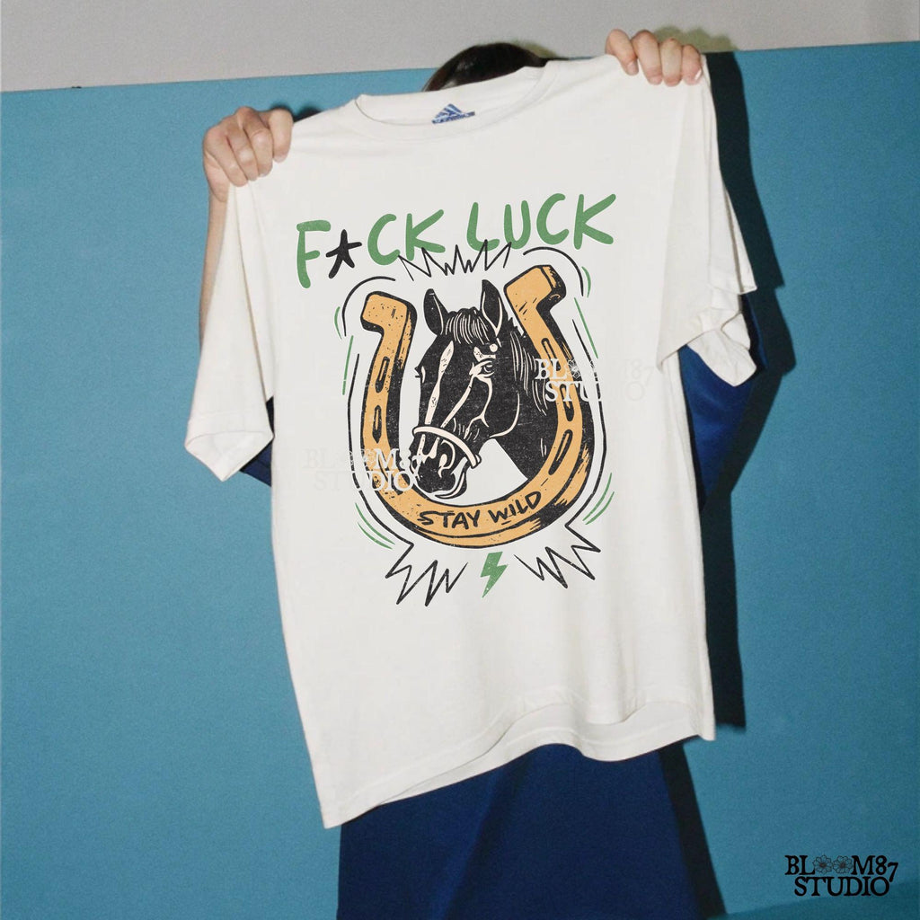 Vintage Western-style PNG featuring a horse inside a horseshoe with lightning bolts, the phrase “Stay Wild,” and an edgy rebellious message.
