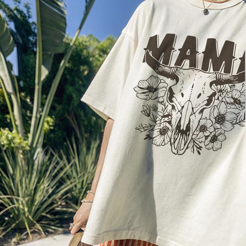 This “Mama” PNG design features a bold western-style font with a longhorn cow skull surrounded by intricate floral elements. A perfect rustic, boho aesthetic for Mother’s Day gifts, rodeo moms, and country-loving mamas. Great for sublimation on T-shirts, mugs, tumblers, tote bags, and DIY crafts. High-resolution transparent PNG for easy printing and creative projects.