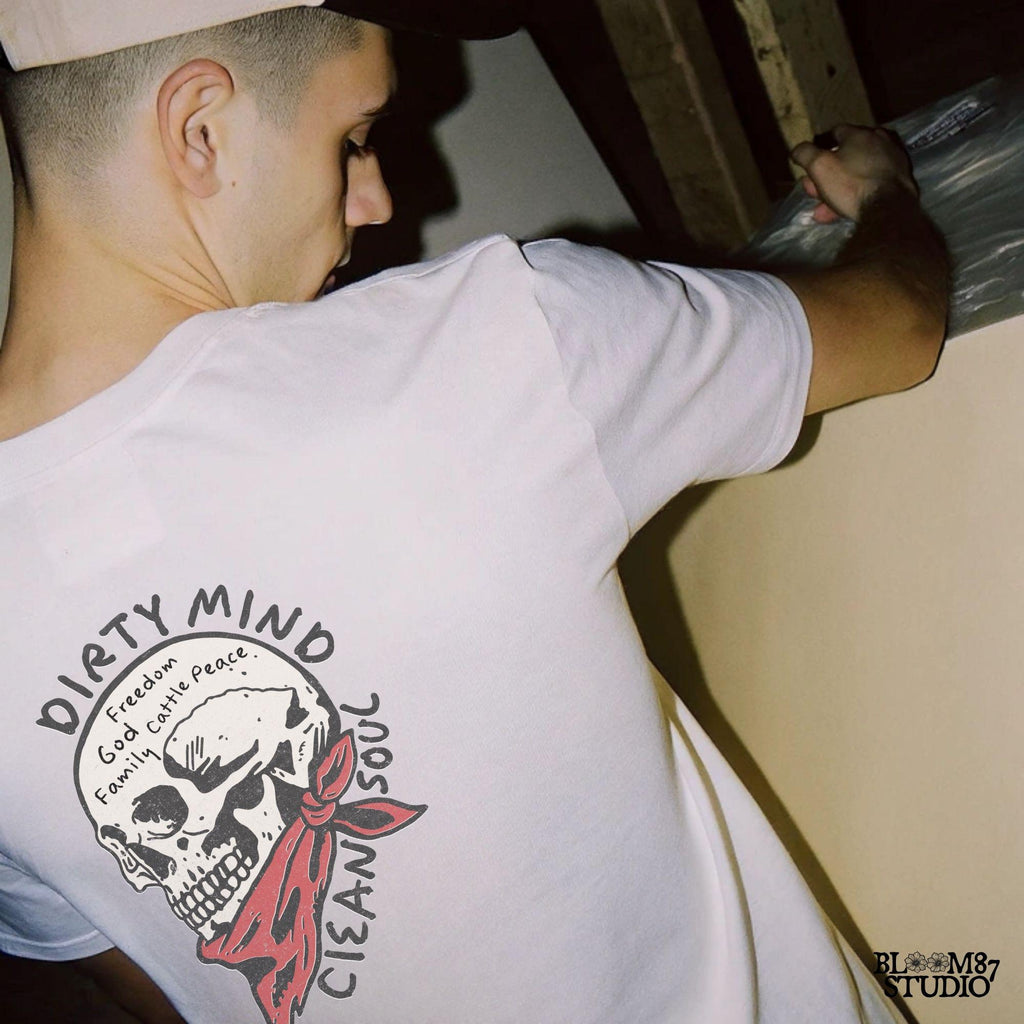 Vintage-style illustration of a cowboy skull wearing a red bandana, featuring handwritten words about freedom, family, and cattle. Perfect for western decor and apparel.