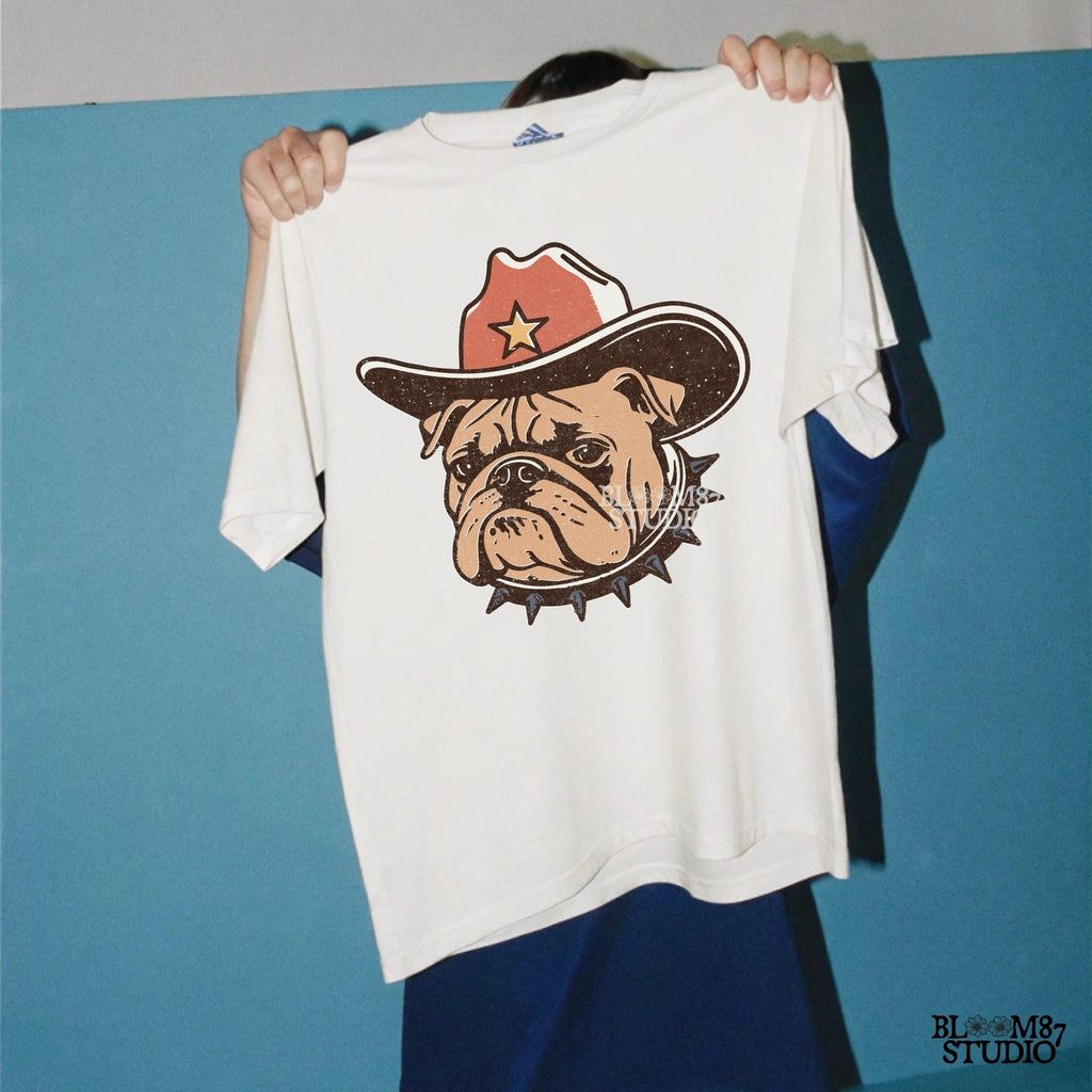 Vintage-style illustration of a tough bulldog wearing a cowboy hat with a star and a spiked collar. Perfect for western decor, rodeo designs, and apparel.