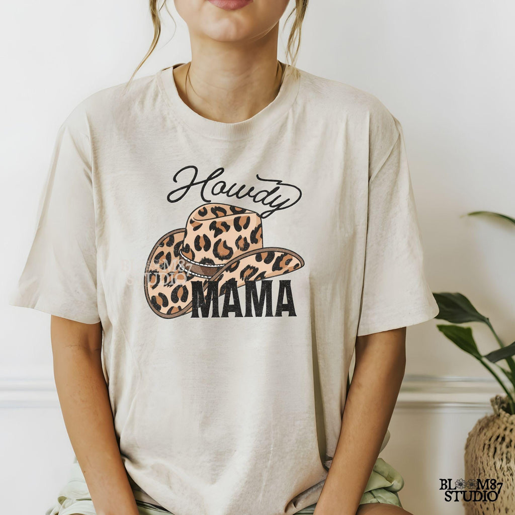 Leopard print cowboy hat with "Howdy Mama" text in a western-style font. Perfect for country-loving moms, rodeo fashion, and cowgirl designs.