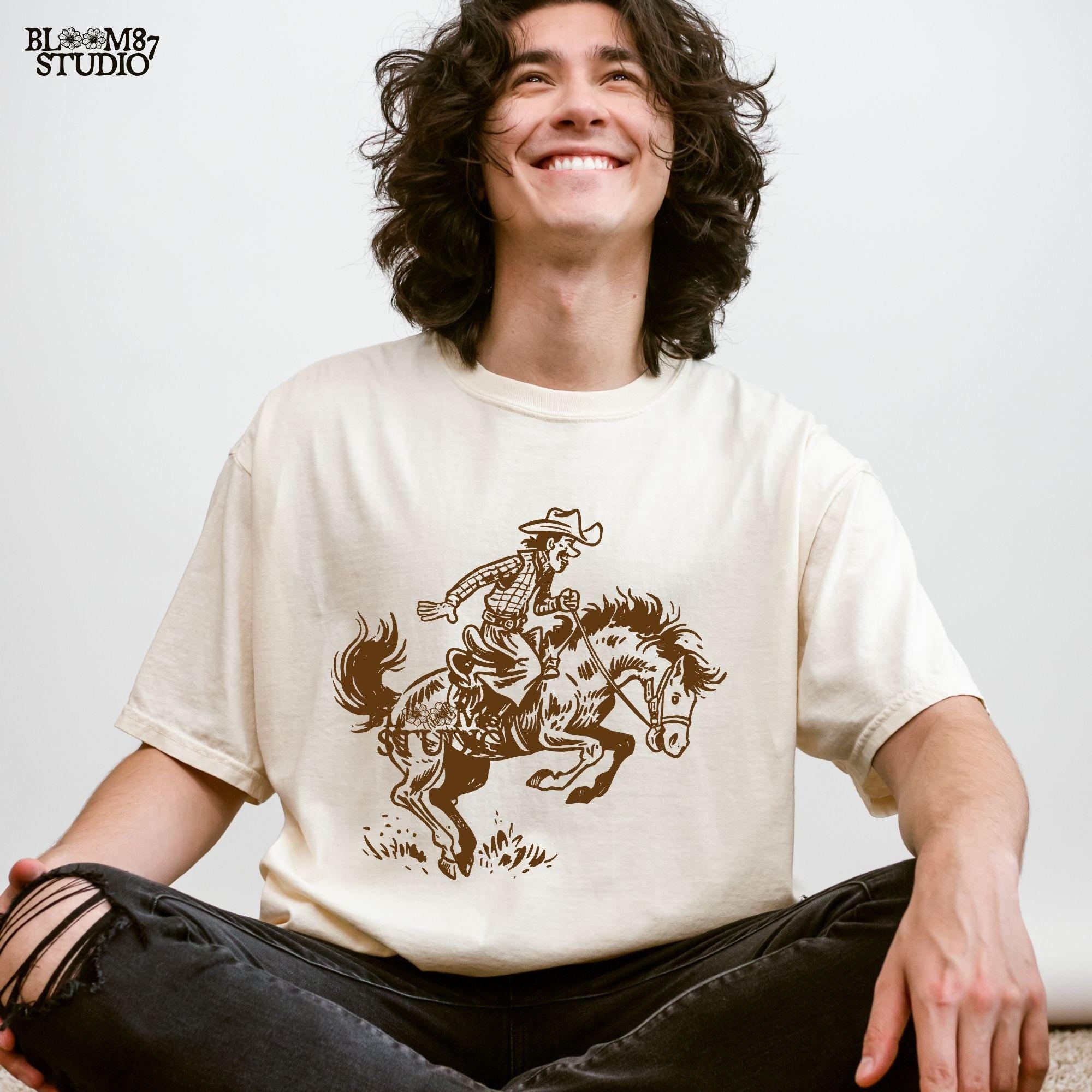 Captures the thrill of bronco riding in a classic Western style, making it a must-have for rodeo events and cowboy-themed apparel.
