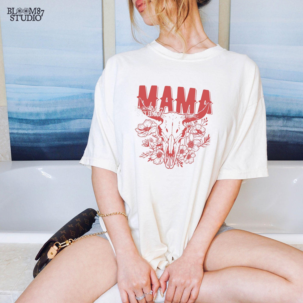 This “Mama” PNG design features a bold western-style font with a longhorn cow skull surrounded by intricate floral elements. A perfect rustic, boho aesthetic for Mother’s Day gifts, rodeo moms, and country-loving mamas. Great for sublimation on T-shirts, mugs, tumblers, tote bags, and DIY crafts. High-resolution transparent PNG for easy printing and creative projects.