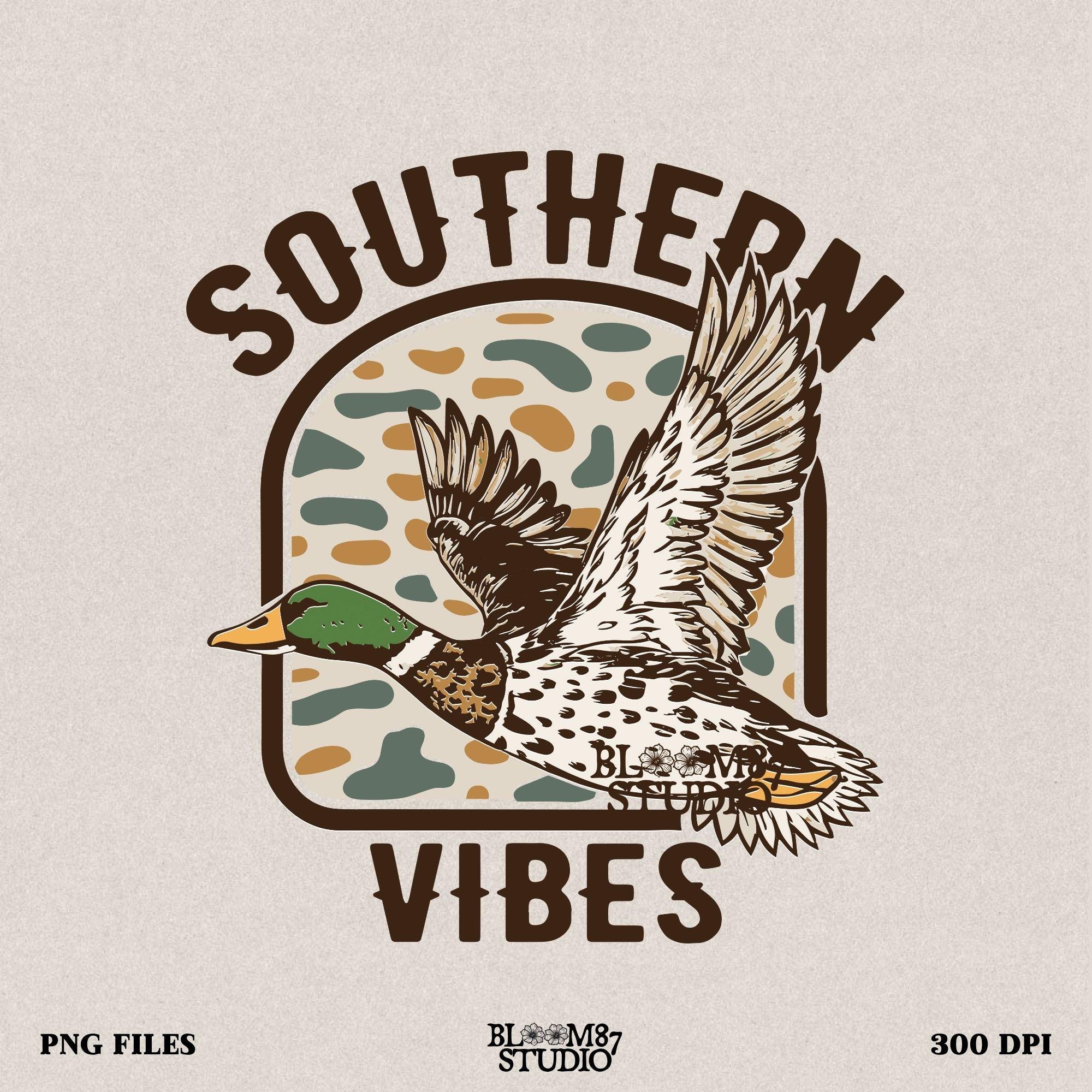 Southern Vibes PNG featuring a detailed flying mallard duck with a camo background, perfect for hunters and outdoor lovers.