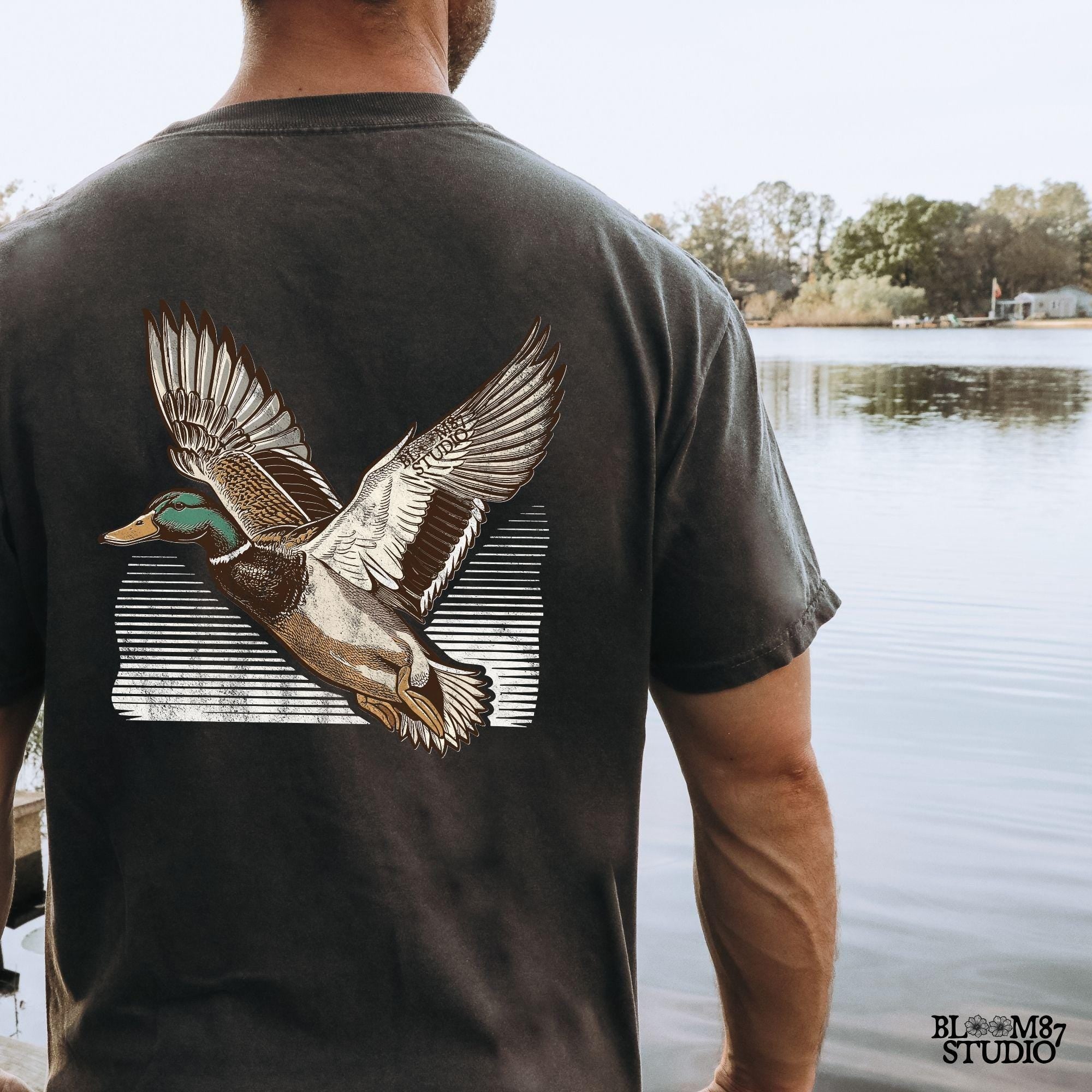 Hunting duck flying PNG, nature enthusiast artwork, printable mallard for t-shirt, detailed mallard feathers PNG, duck flying toward horizon, wildlife vintage design, bird hunting apparel file, artistic bird in motion PNG, duck hunting passion design