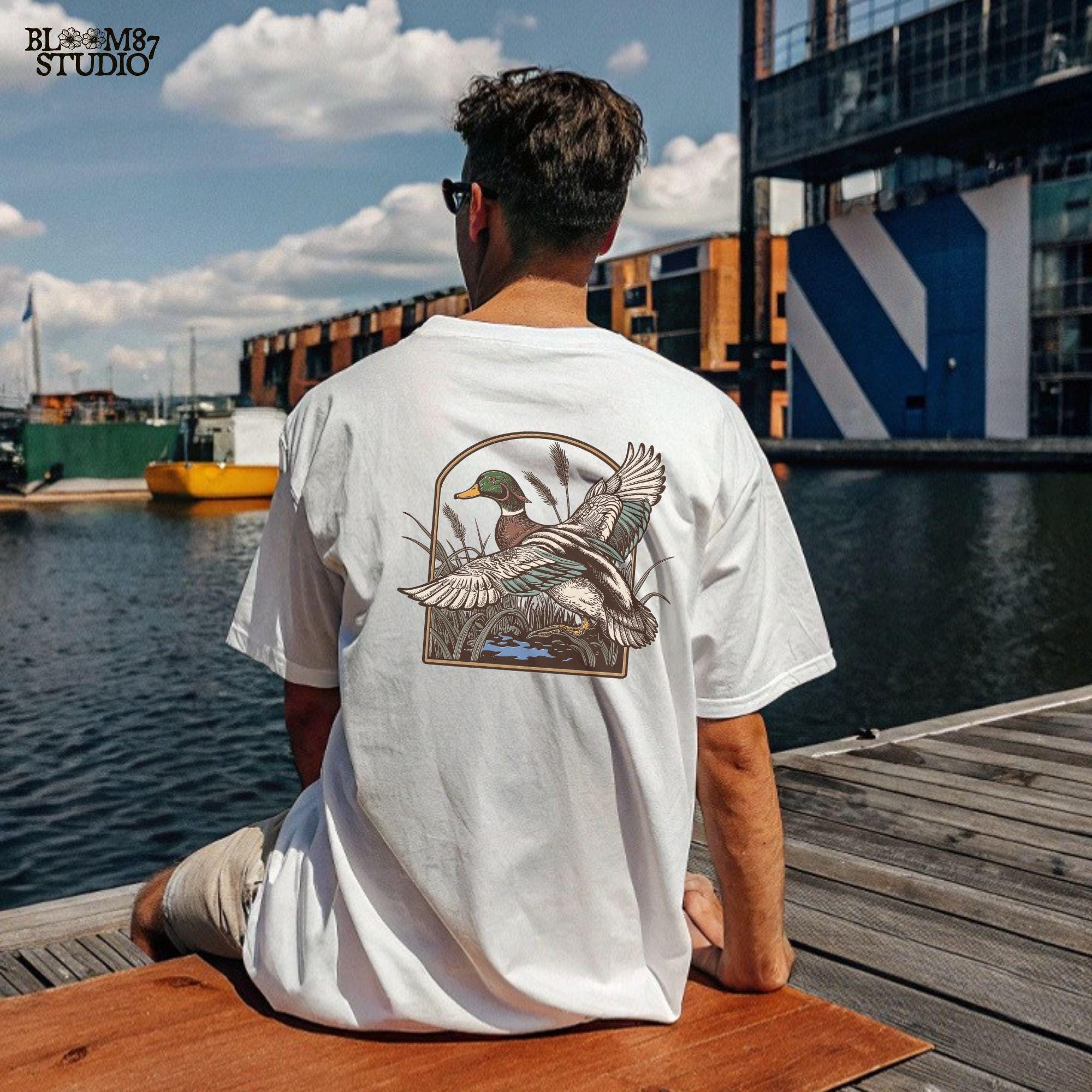 vintage wildlife clipart, flying bird png for shirts, detailed mallard illustration, duck hunting graphic art, outdoor nature scene png, rustic animal design file, mallard in nature, duck clipart for mugs, wild duck digital image, wings spread png