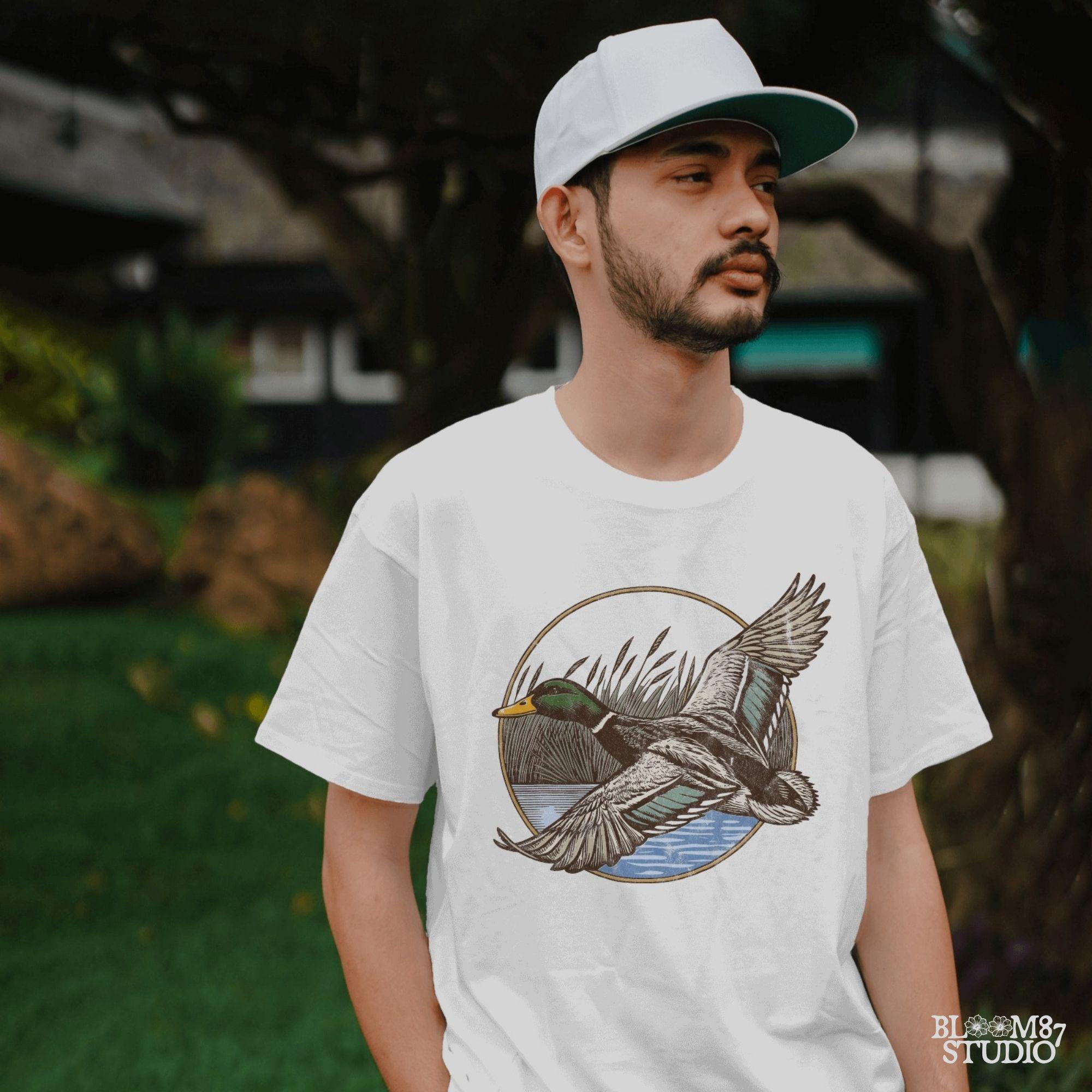 "Vintage flying mallard duck PNG clipart in marsh scene, rustic wildlife sublimation design for duck hunting shirts and outdoor gear"