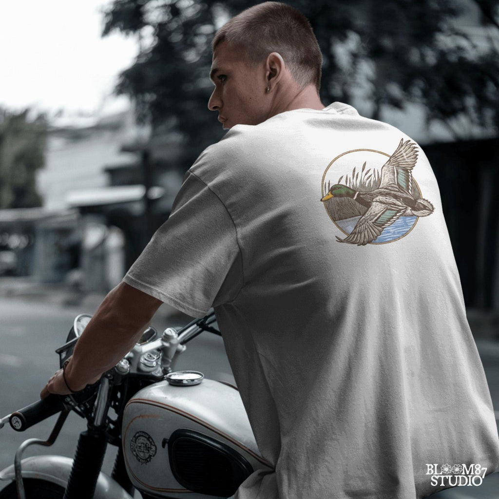 "Vintage flying mallard duck PNG clipart in marsh scene, rustic wildlife sublimation design for duck hunting shirts and outdoor gear"