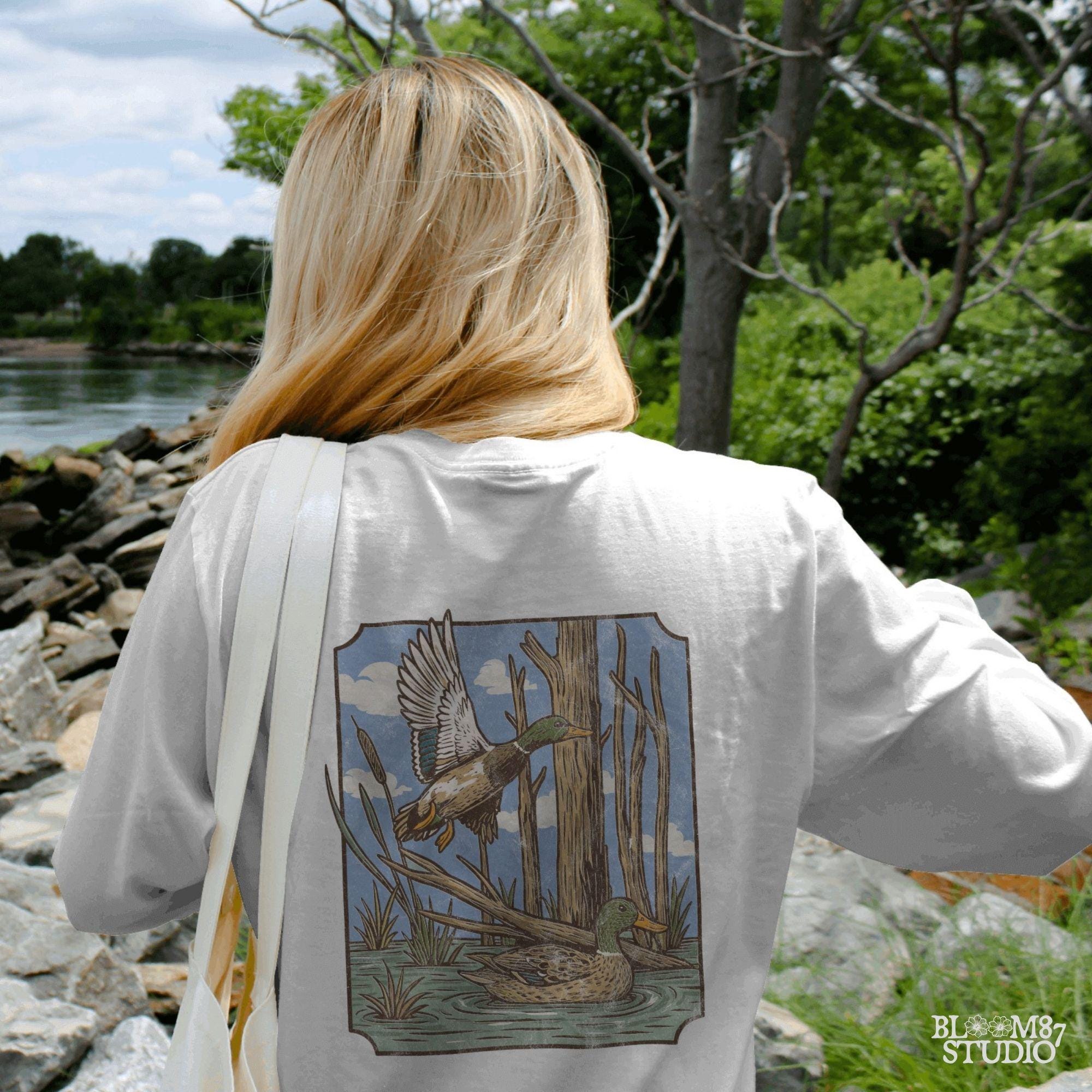 “Vintage mallard duck PNG, flying and swimming ducks in swamp with trees, classic waterfowl hunting scene sublimation”