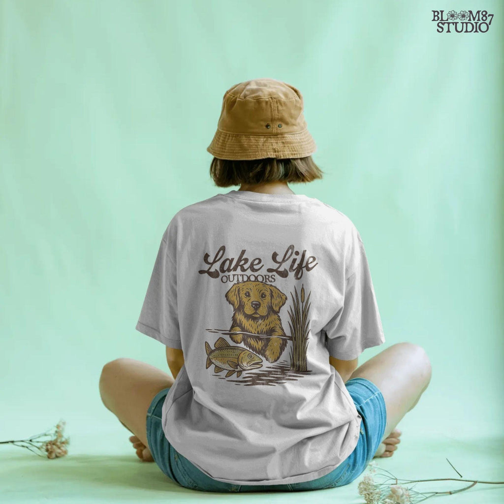 Golden Retriever dog enjoying lake life outdoors with fish in rustic nature setting — perfect for lake house and fishing sublimation designs