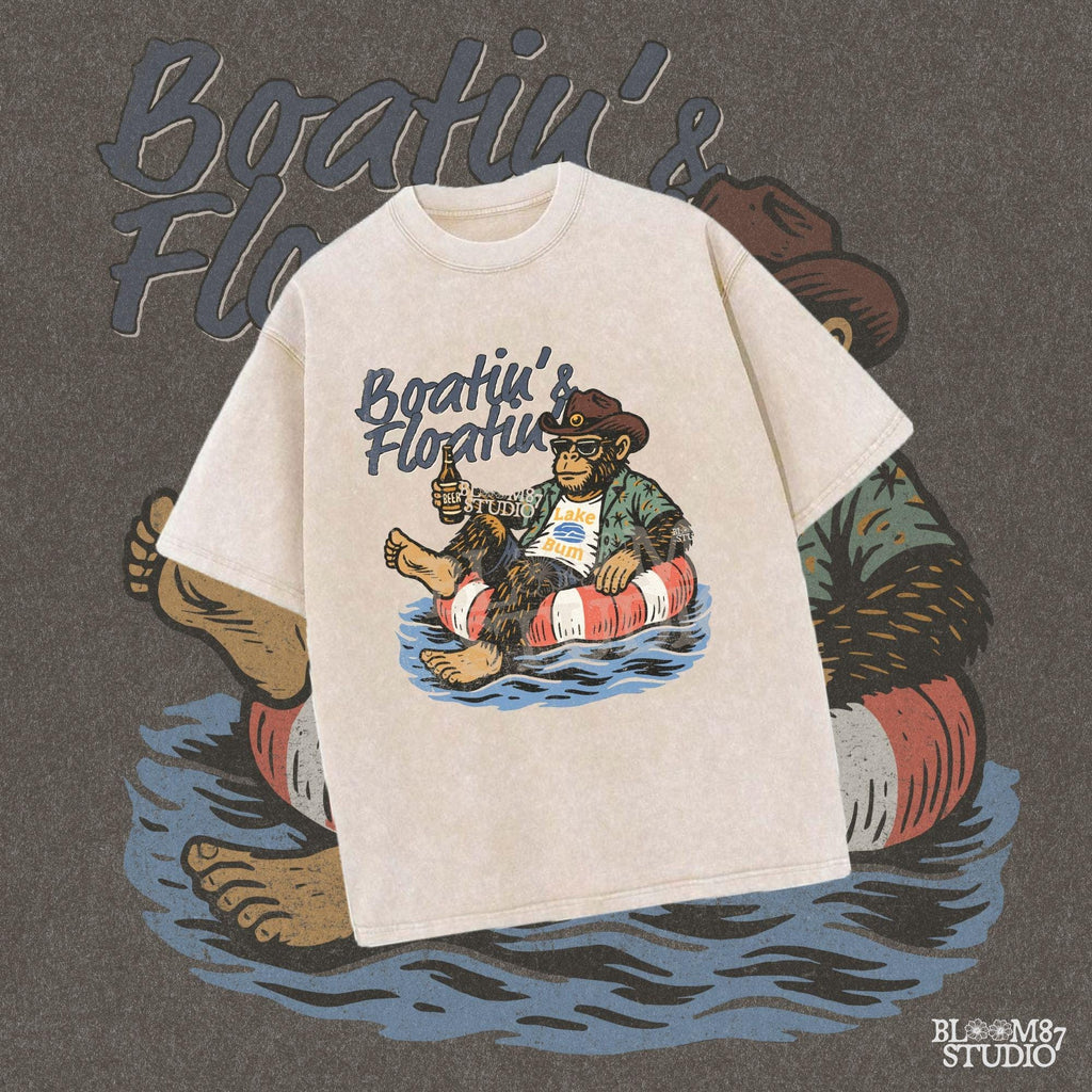 Bigfoot relaxing in a red and white pool float, holding a beer and wearing sunglasses, a hat, and a tropical shirt with “Boatin’ & Floatin’” text above.