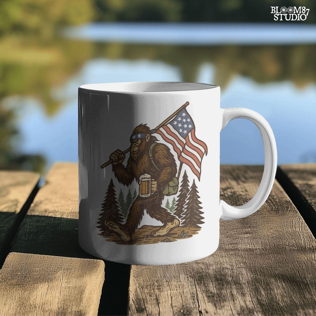 Patriotic bigfoot carrying American flag and beer mug in forest, funny summer USA PNG design.