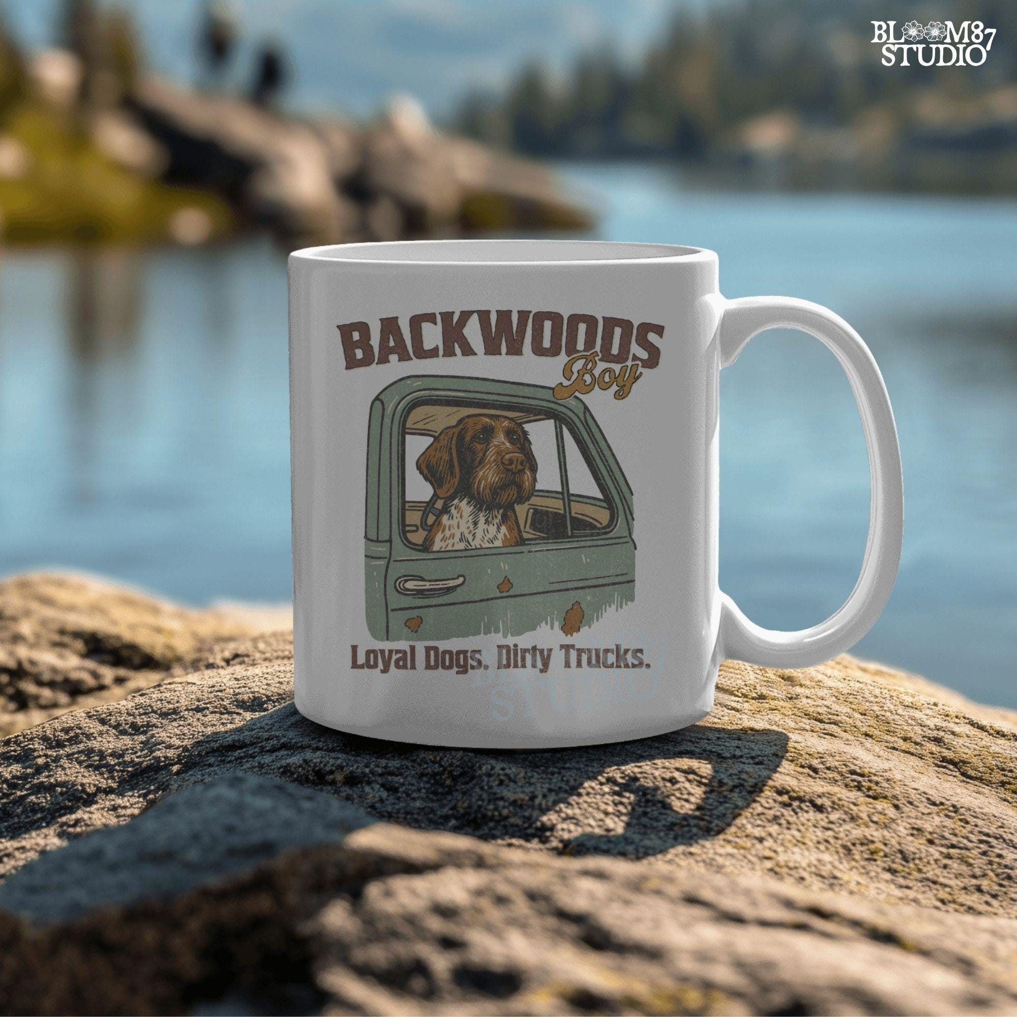 German Wirehaired Pointer hunting dog in rustic truck window with text “Backwoods Boy” and phrase “Loyal Dogs. Dirty Trucks.”