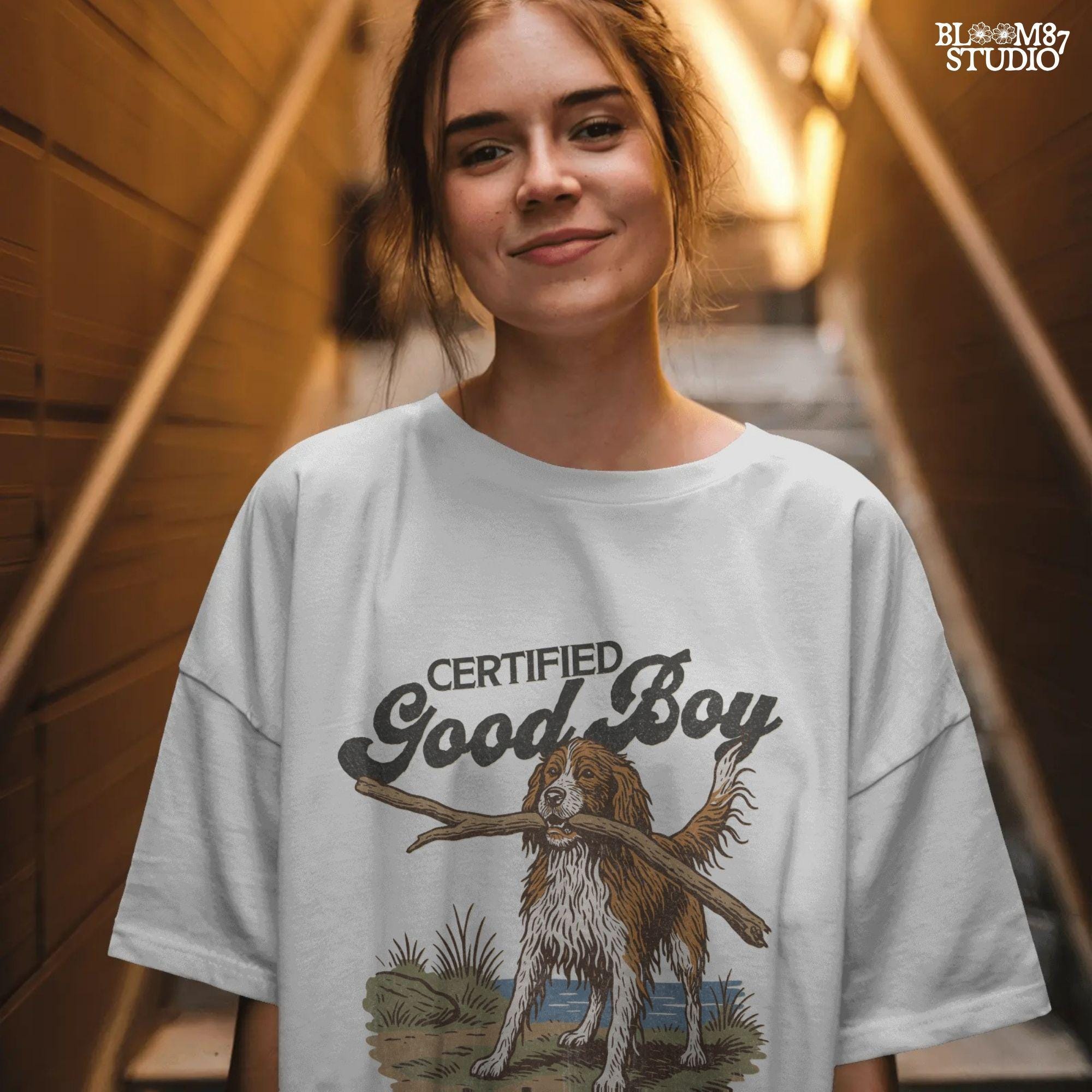 Brittany Spaniel dog holding a stick with text Certified Good Boy and Backwoods Life Club, rustic hunting dog art