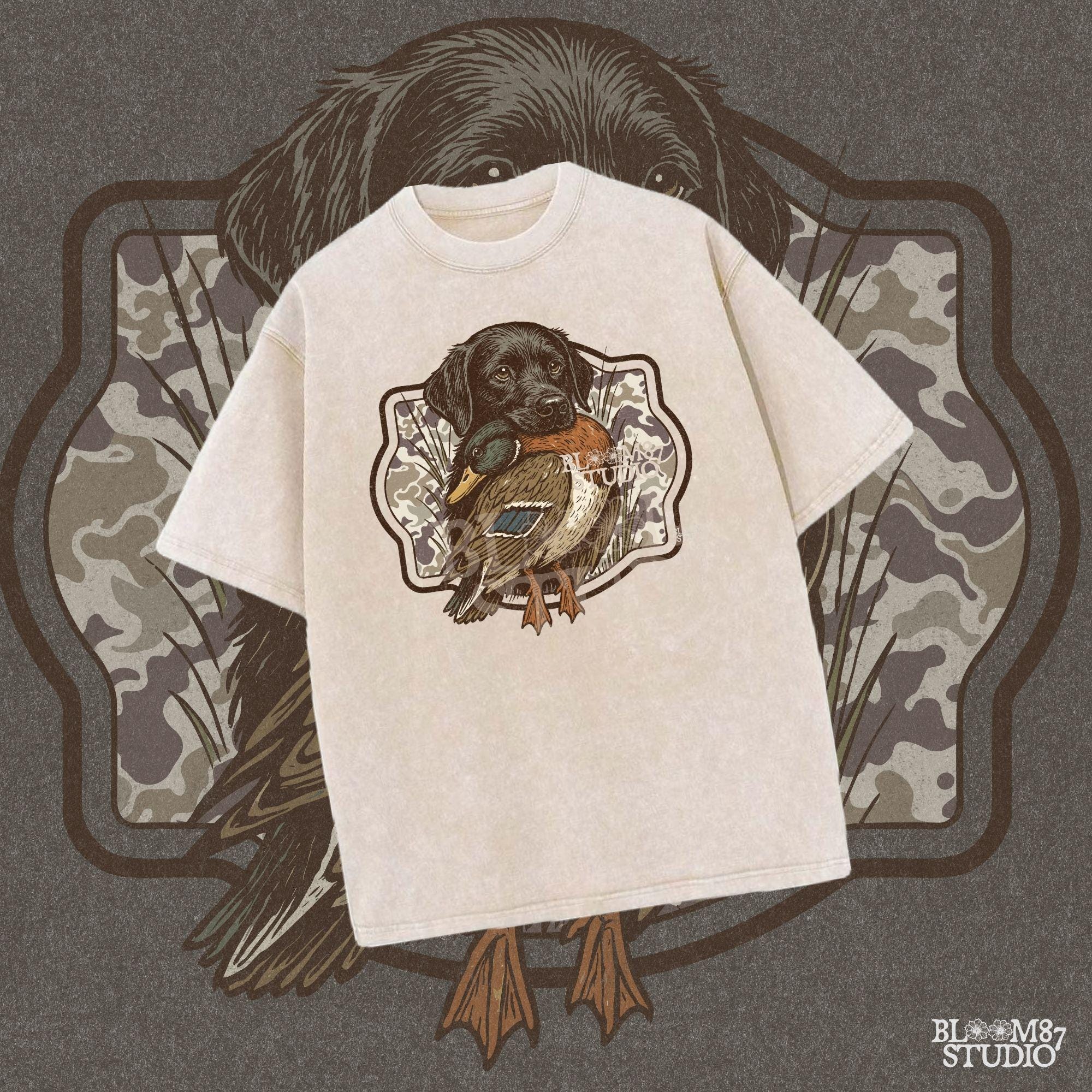 Black Labrador retriever holding a mallard duck with a camouflage background, perfect for hunting or outdoors-themed designs.