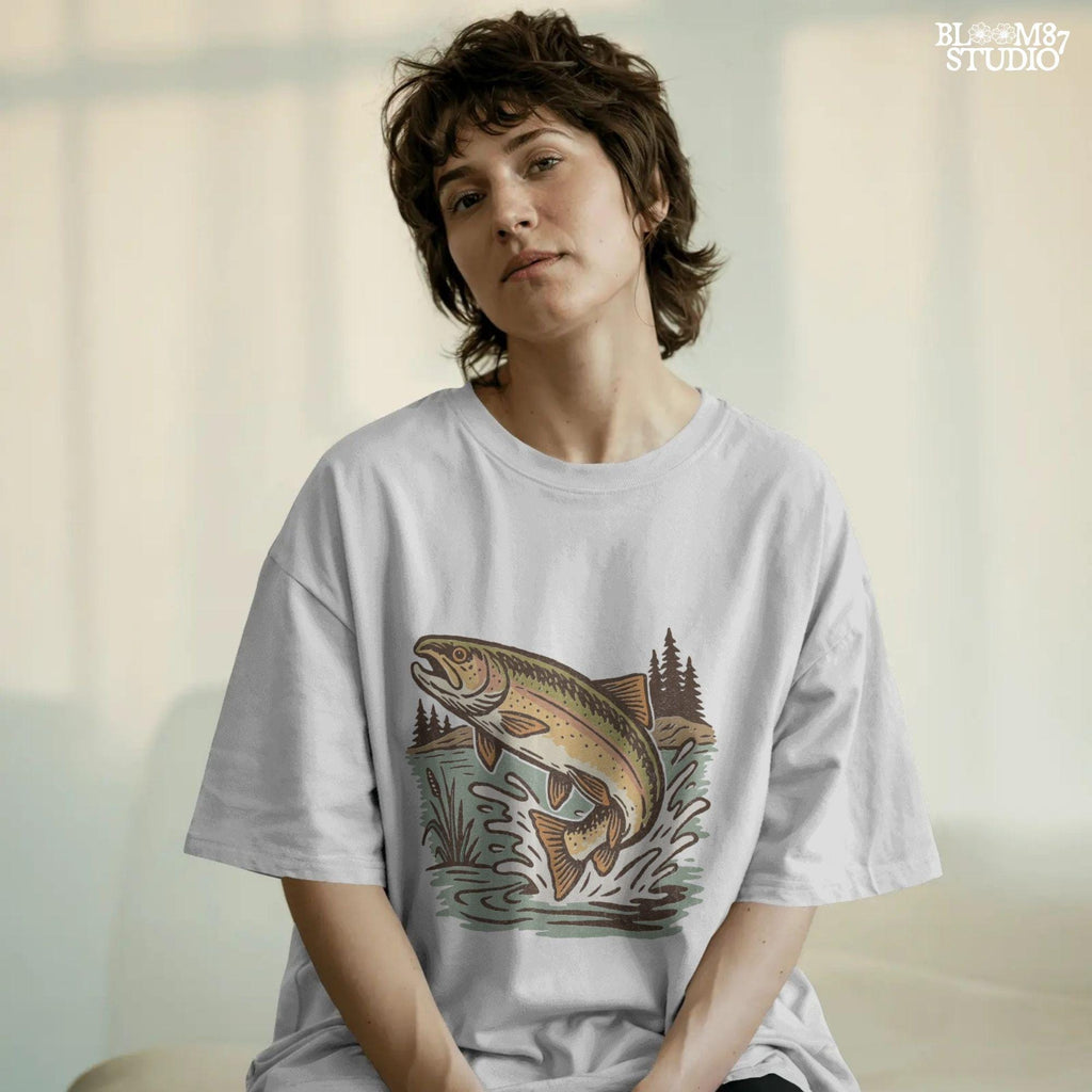 Illustrated trout leaping from the river surrounded by reeds and pine trees, perfect for summer fishing and outdoor adventure designs.