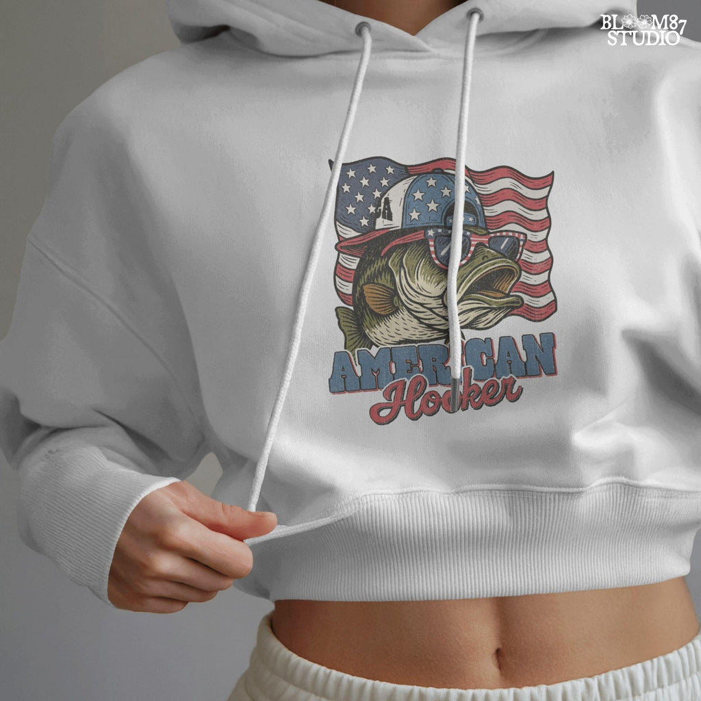 Patriotic cartoon largemouth bass wearing USA sunglasses and a hat in front of the American flag, with the text “American Hooker”.
