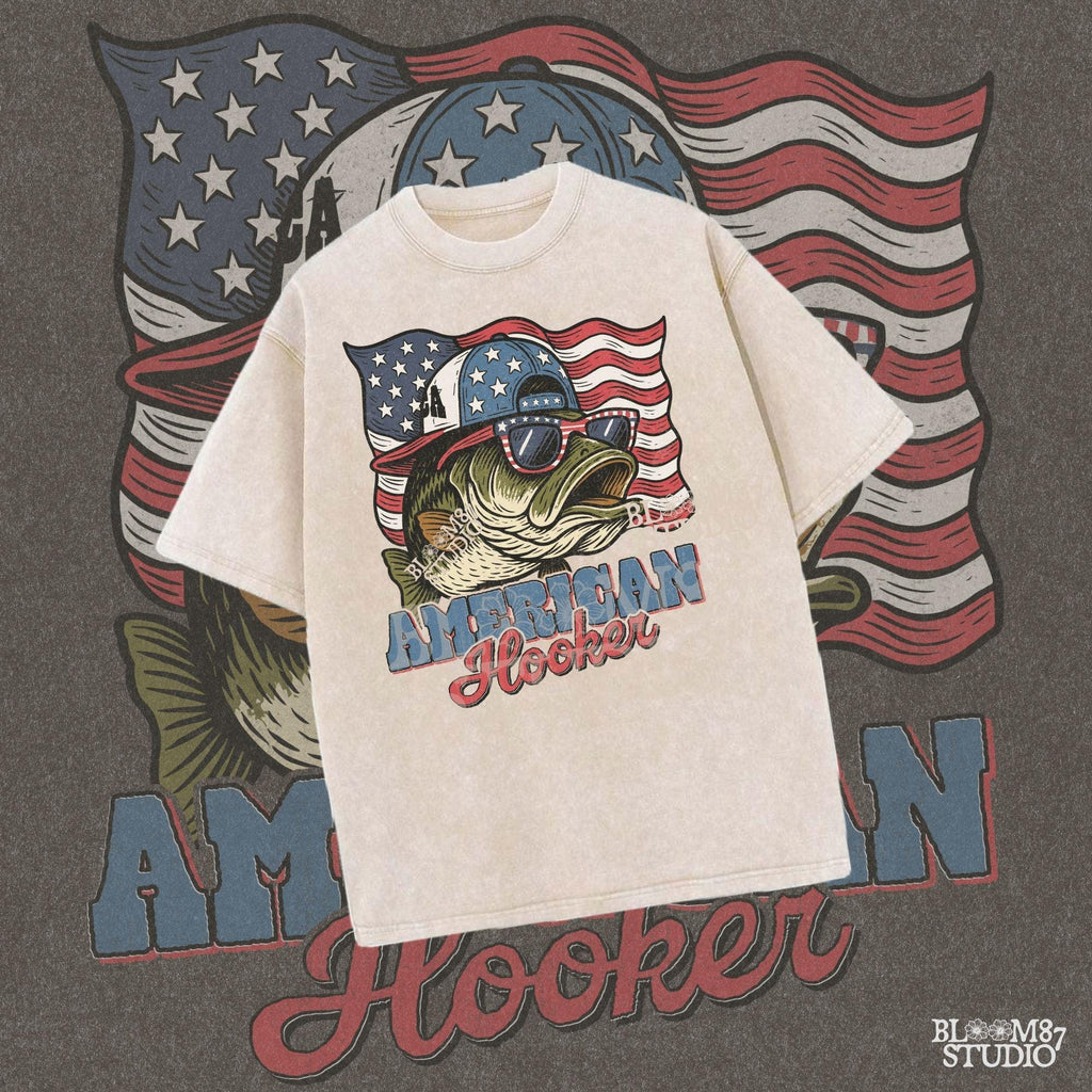 Patriotic cartoon largemouth bass wearing USA sunglasses and a hat in front of the American flag, with the text “American Hooker”.