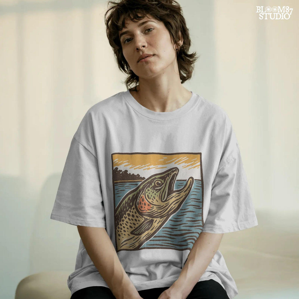 Vintage woodcut-style illustration of a trout fish leaping from the water at sunset, with a bold orange sky and retro color palette.