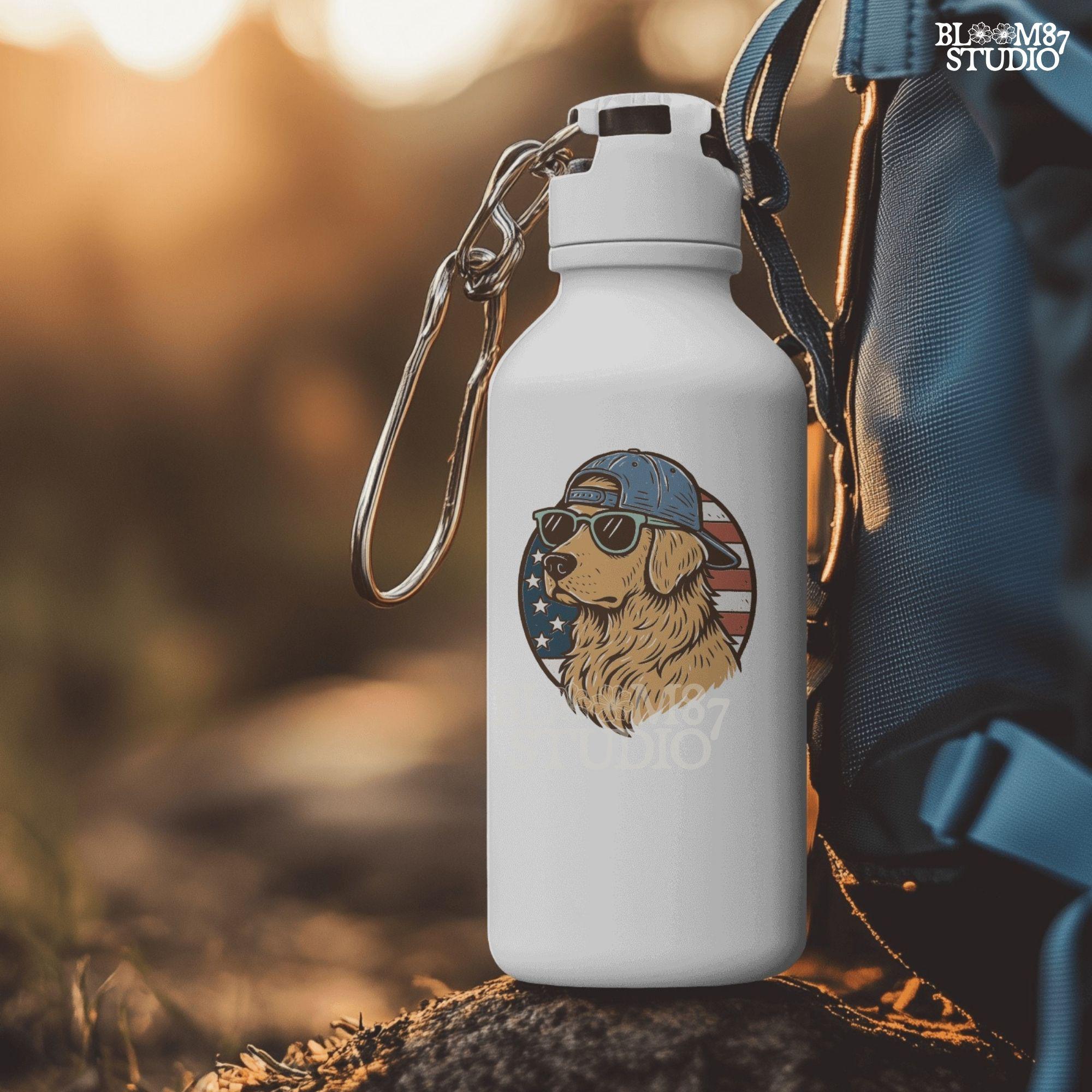 Cool golden retriever wearing sunglasses and a backwards cap in front of a circular American flag background.