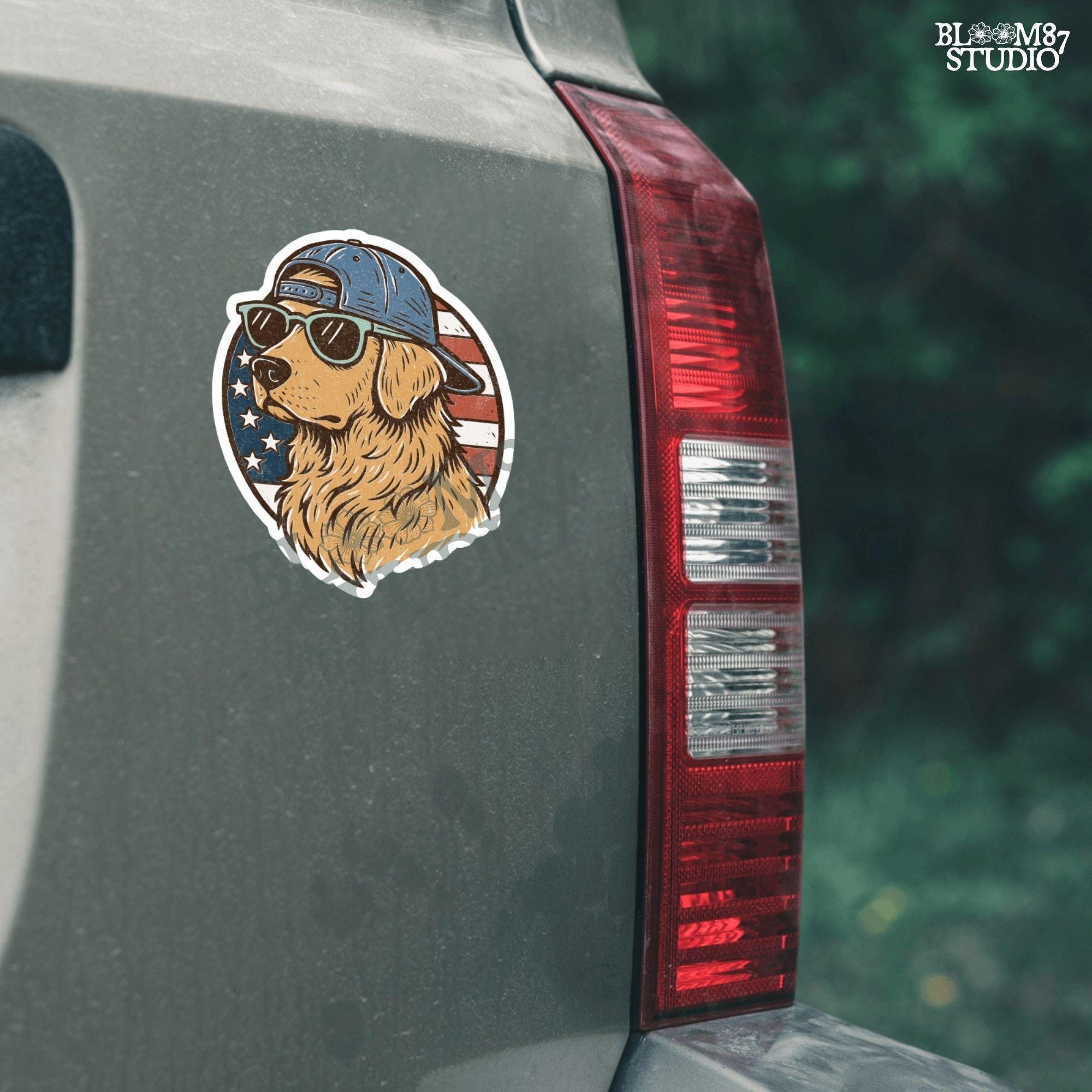 Cool golden retriever wearing sunglasses and a backwards cap in front of a circular American flag background.