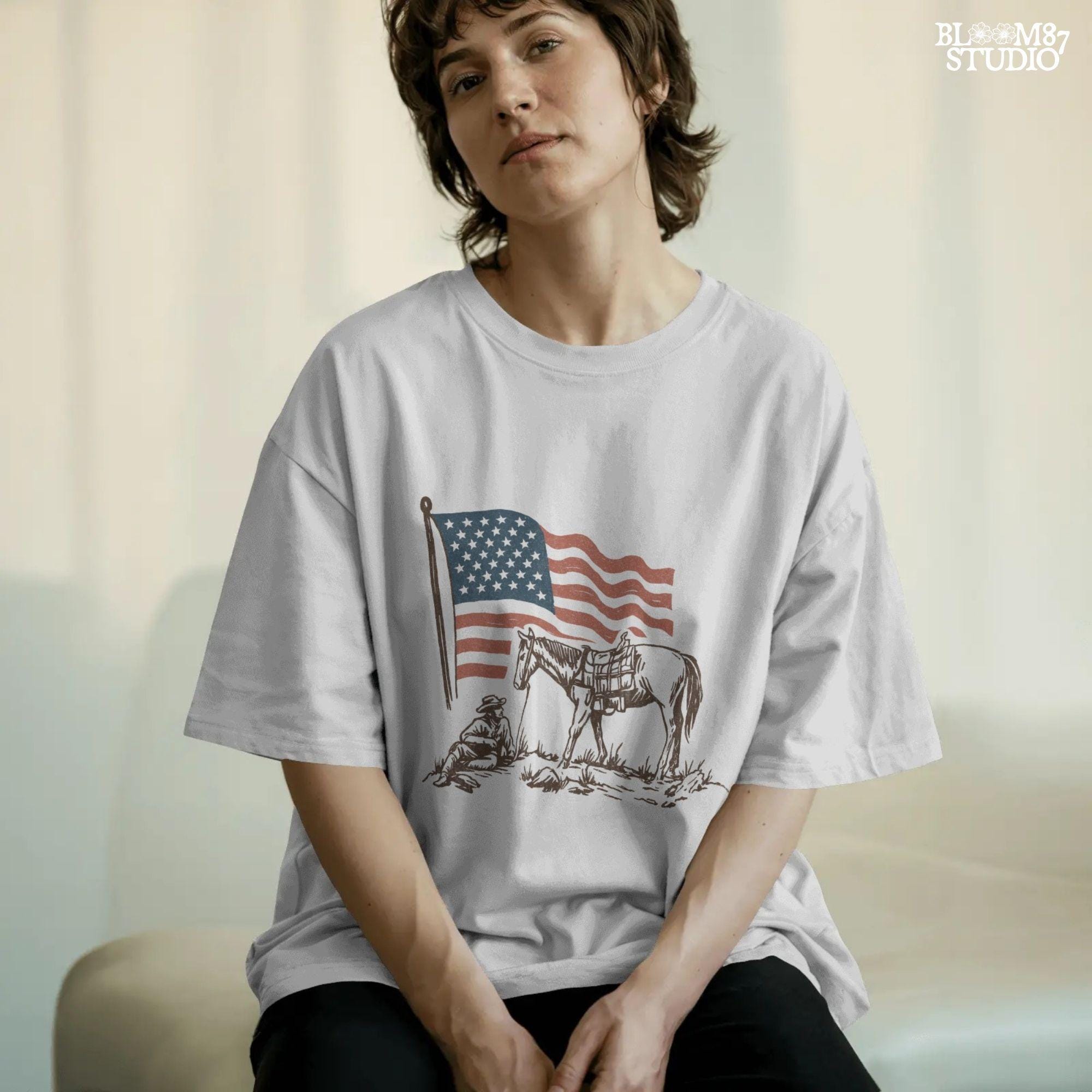 Vintage-style illustration of a cowboy sitting beside a saddled horse under a waving American flag.