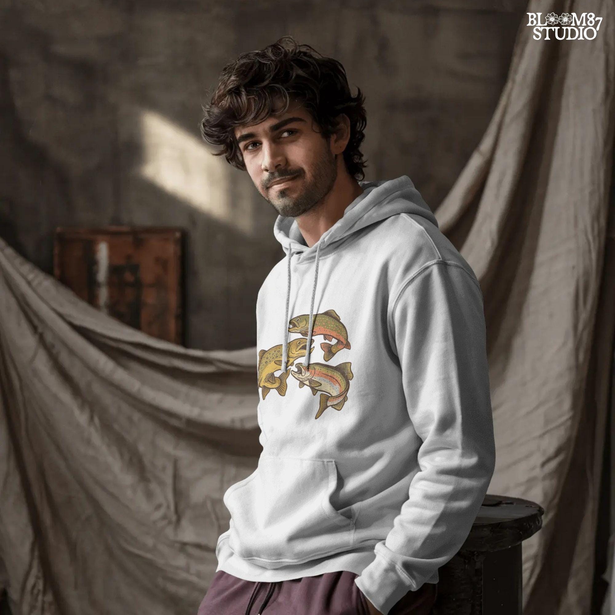 Illustration of rainbow trout, brook trout, and brown trout in colorful, vintage-style drawing with open mouths and detailed markings.