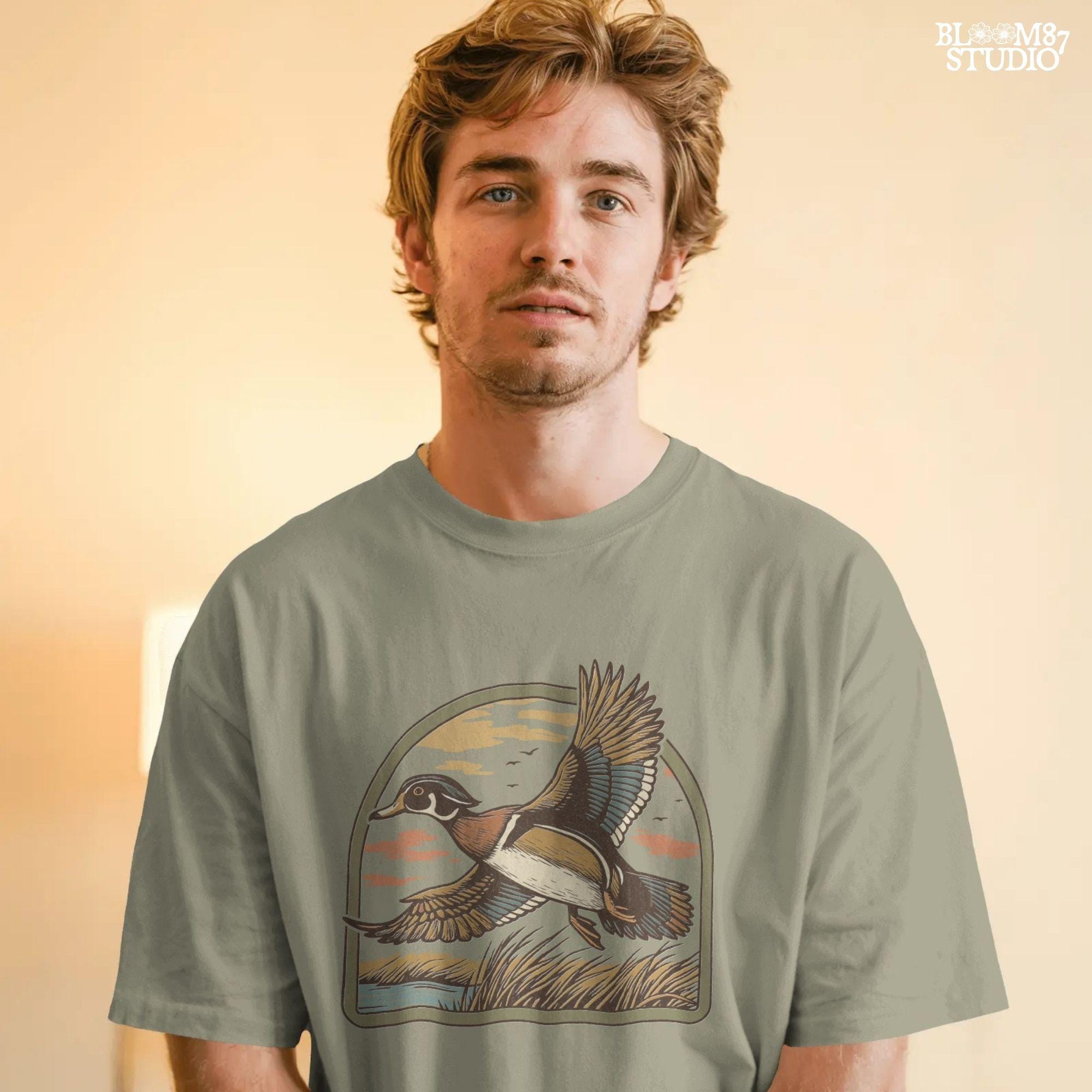 Illustration of a wood duck flying above a marsh at sunset with warm-toned clouds, cattails, and a reflective waterline.