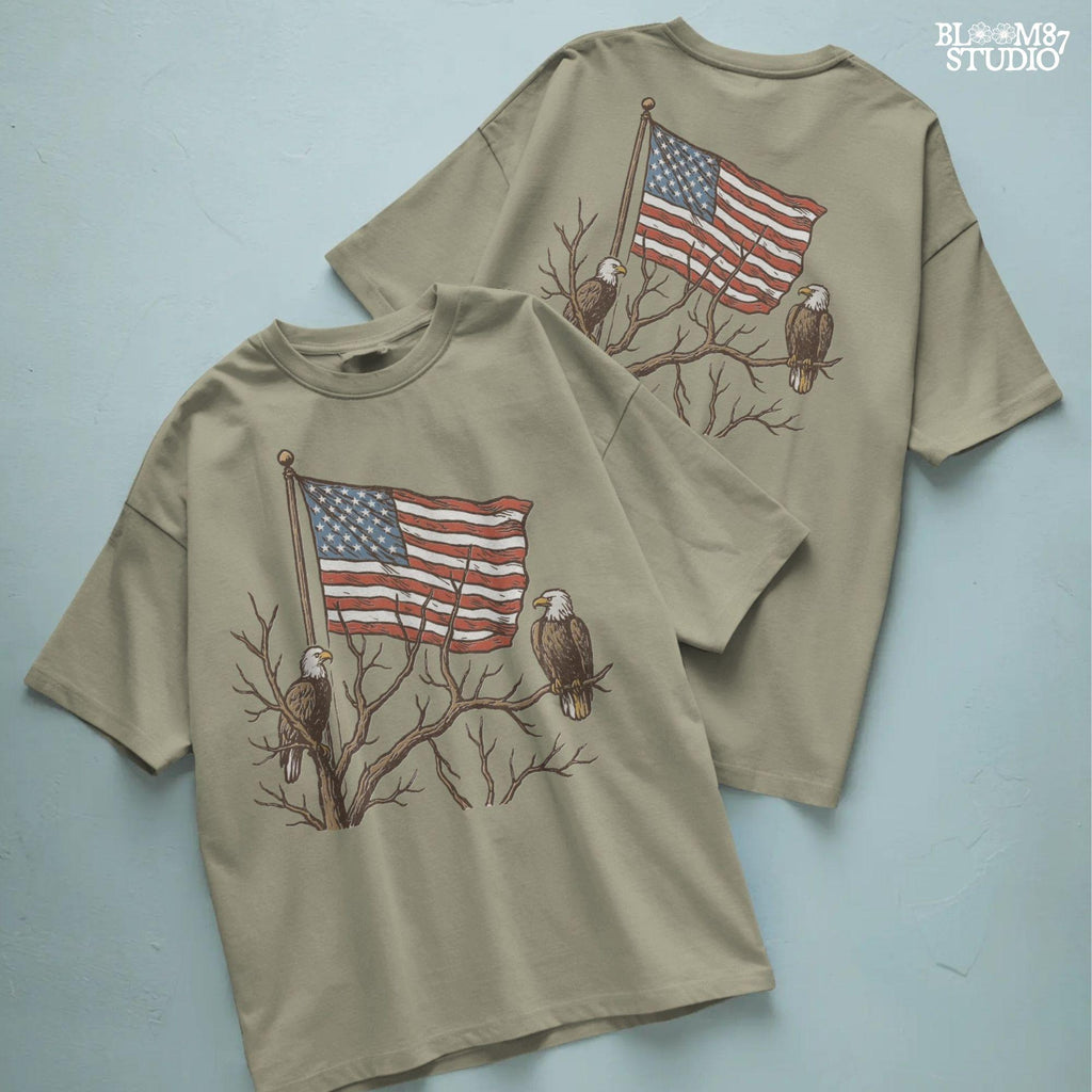 Two bald eagles perched on leafless tree branches in front of a waving American flag in a vintage-style illustration.