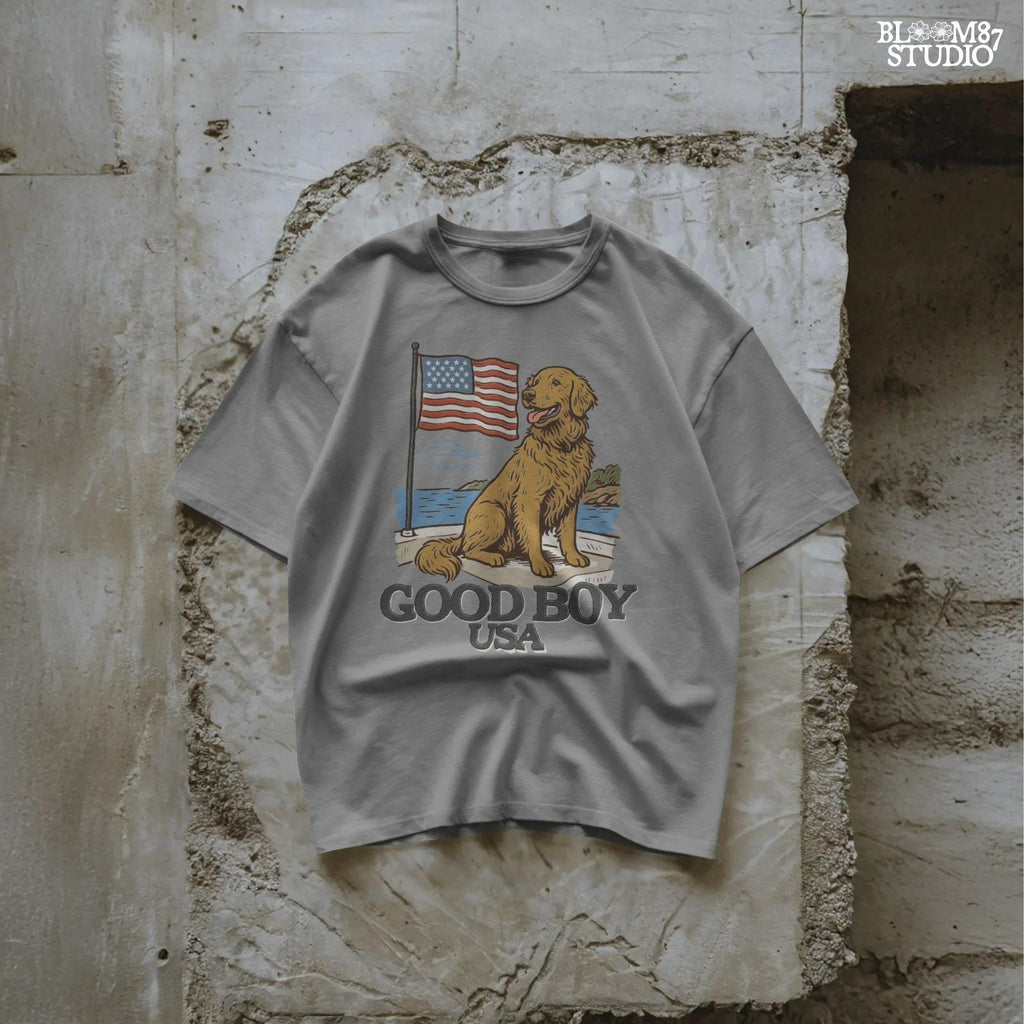 Golden retriever sitting proudly in front of the American flag with “Good Boy USA” text below, patriotic dog design