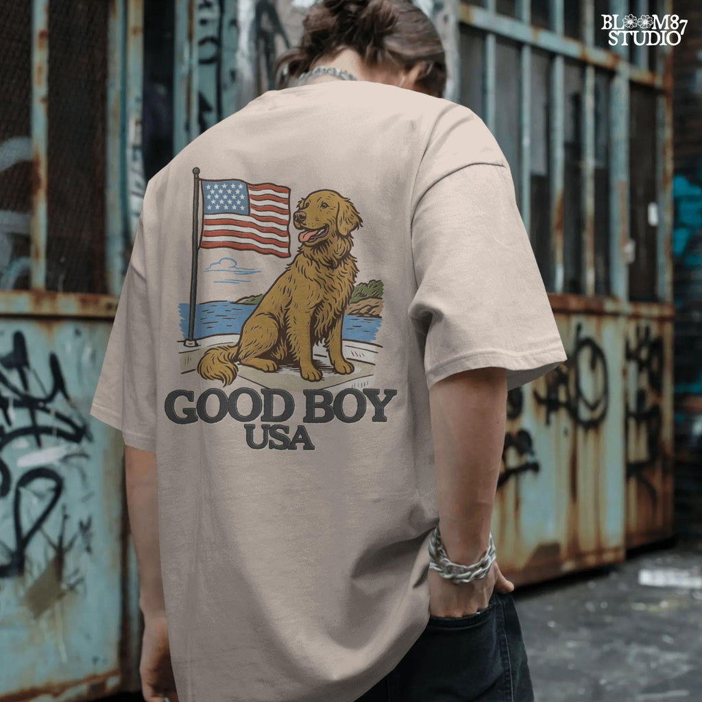 Golden retriever sitting proudly in front of the American flag with “Good Boy USA” text below, patriotic dog design