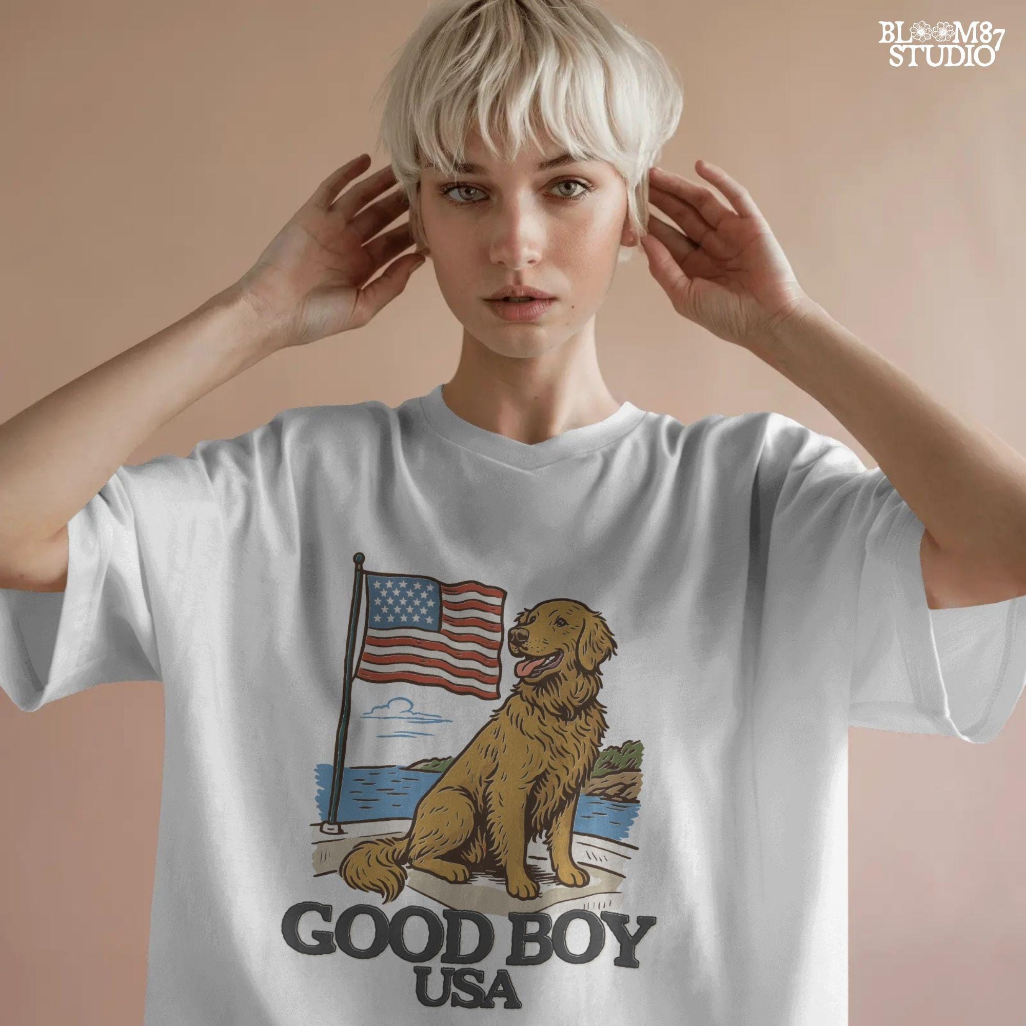 Golden retriever sitting proudly in front of the American flag with “Good Boy USA” text below, patriotic dog design