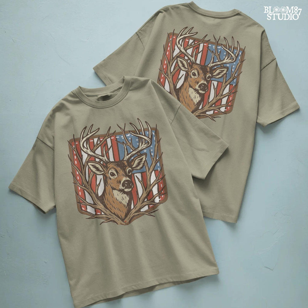 Illustration of a proud buck with large antlers standing in front of a stitched American flag patch, rustic hunting style.