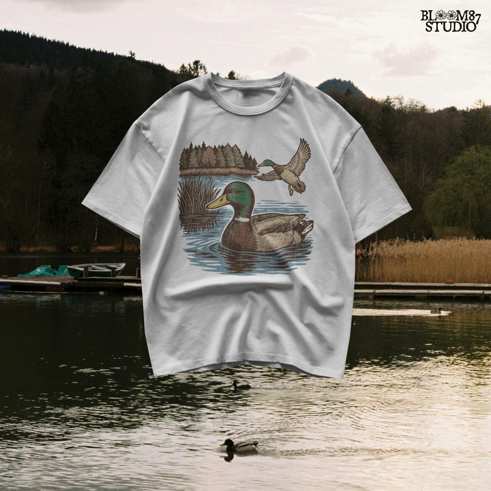 Two mallard ducks in a peaceful summer lake scene with pine trees and blue water, one swimming and one flying.