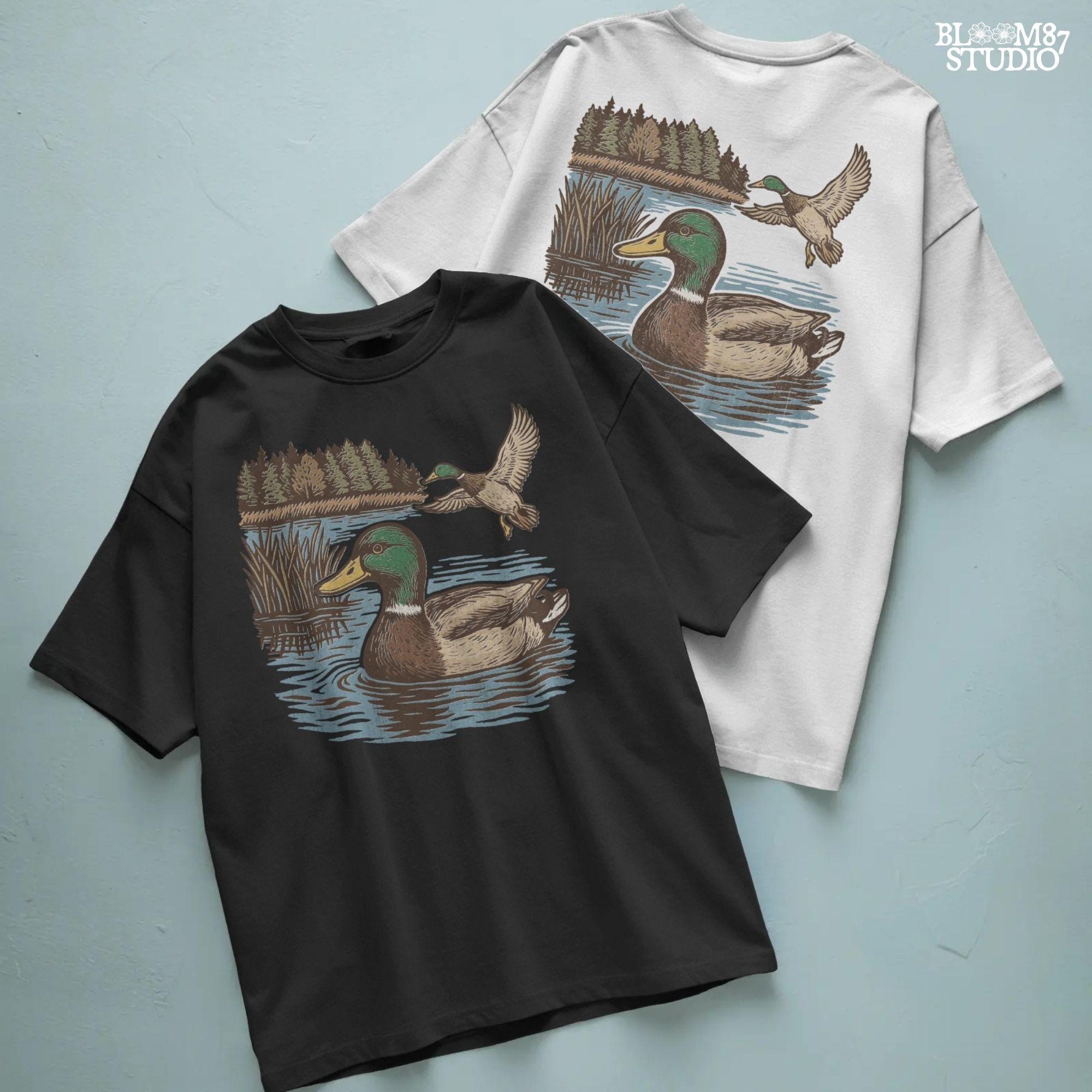 Two mallard ducks in a peaceful summer lake scene with pine trees and blue water, one swimming and one flying.