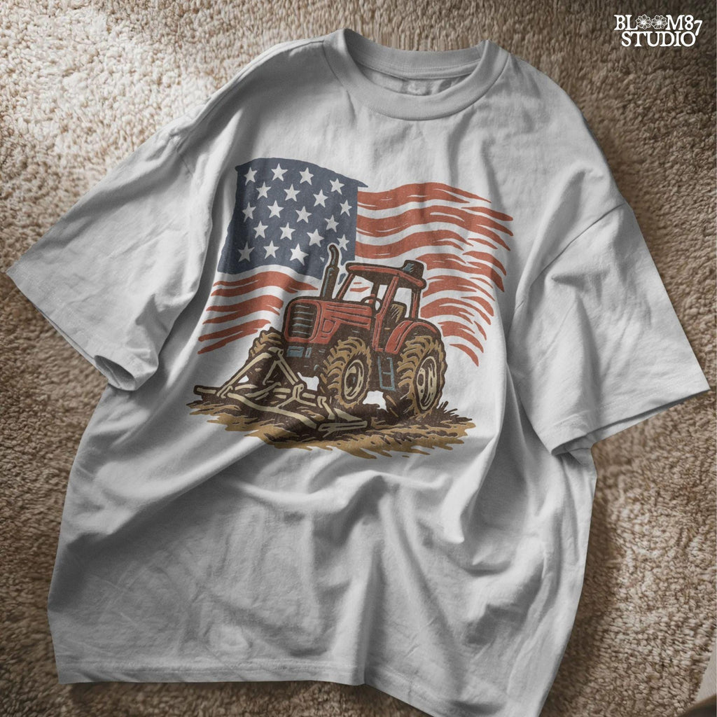 Red tractor with plow on soil, American flag waving in the background, vintage farm-themed graphic.