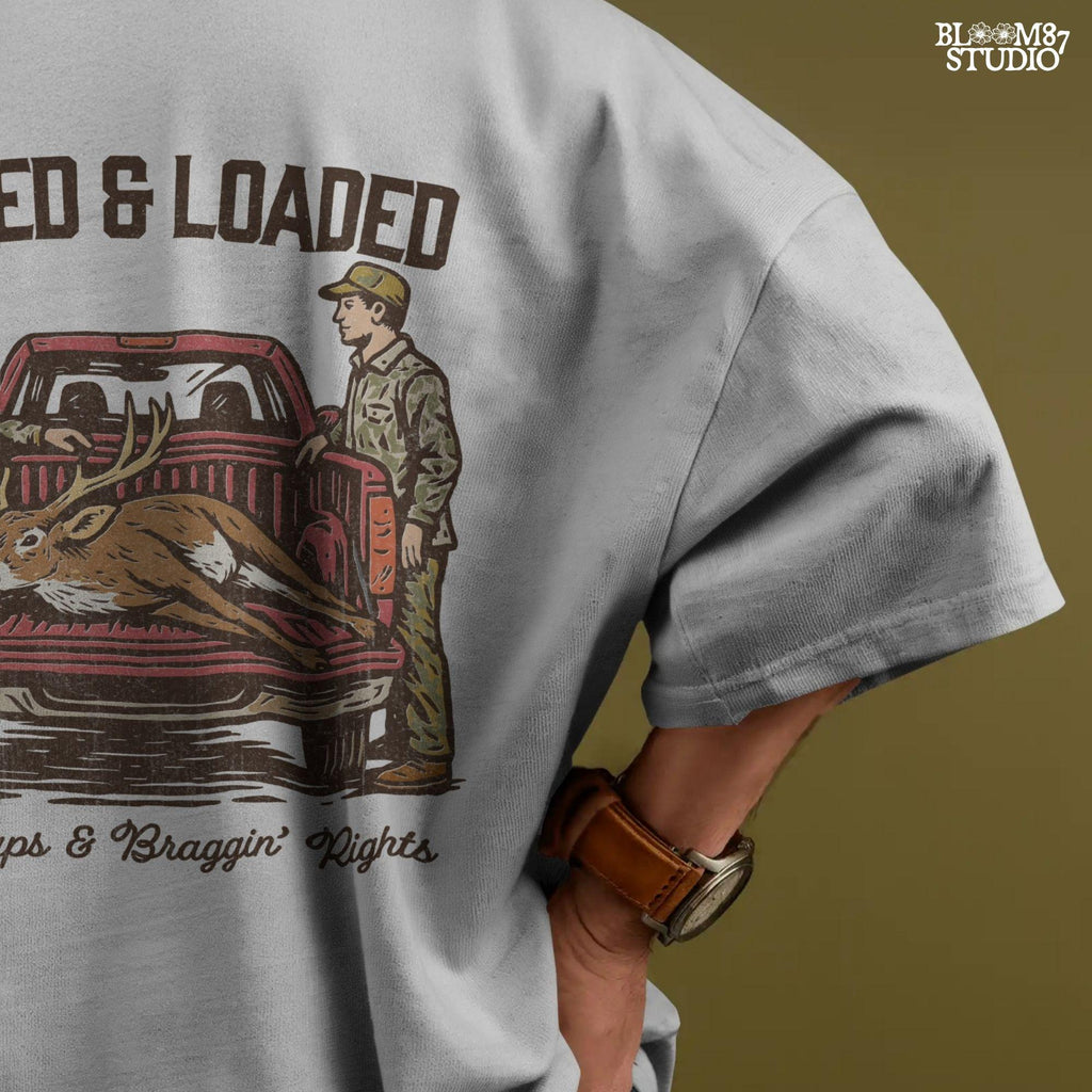 Rustic hunting design with two hunters, a truck, and a buck in the bed. Tagged and Loaded quote for deer season and outdoor graphics.