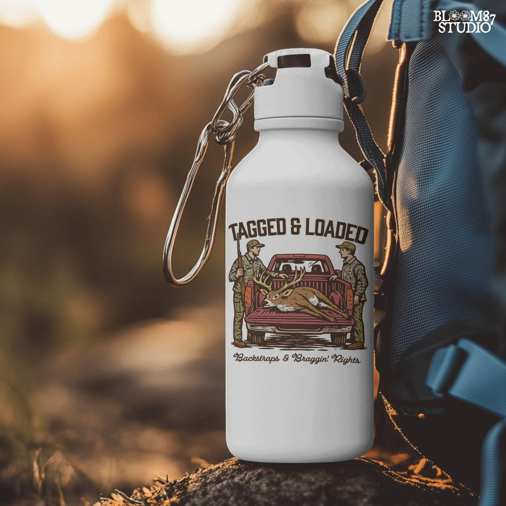 Rustic hunting design with two hunters, a truck, and a buck in the bed. Tagged and Loaded quote for deer season and outdoor graphics.