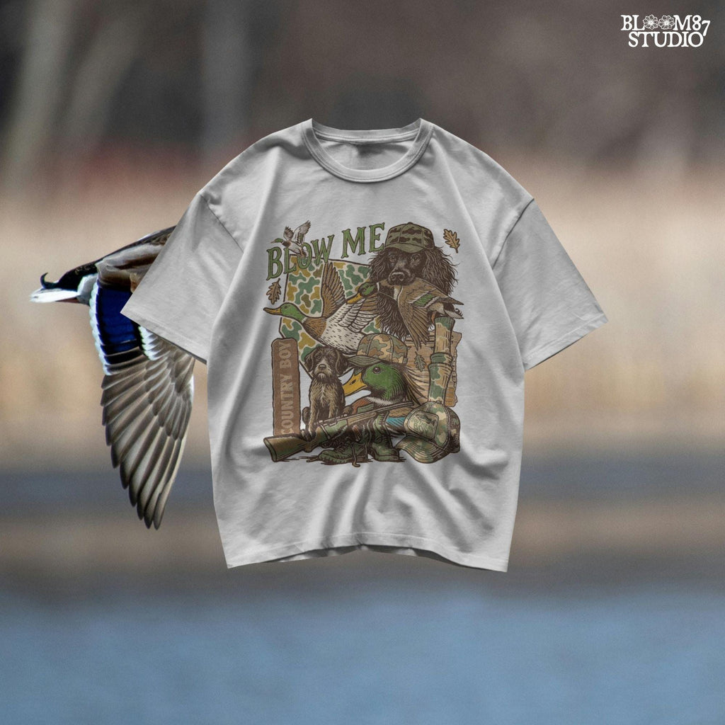 Retro collage of duck hunting elements including mallards, camo, duck dog, country boy rifle, and “Blow Me” southern humor quote.