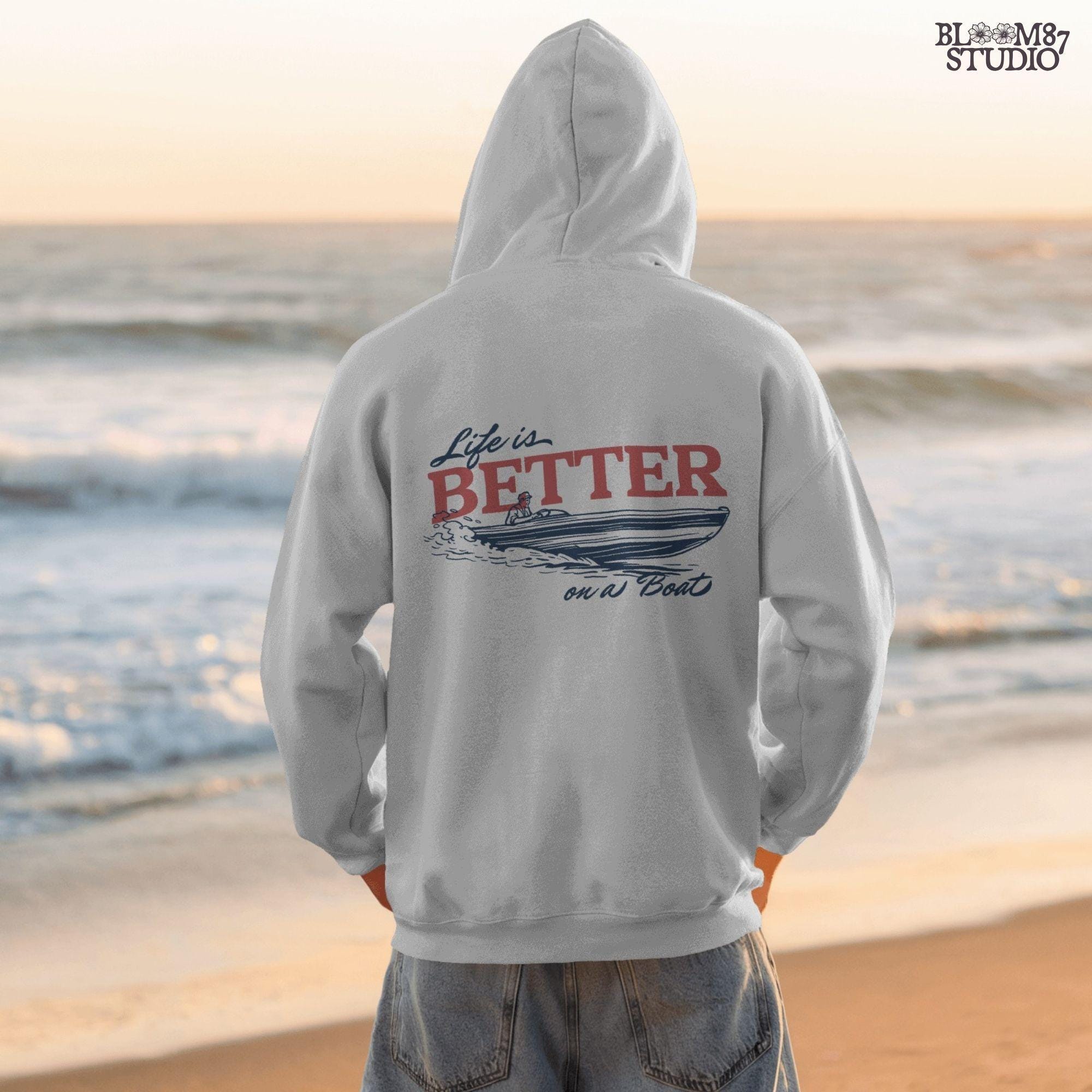 “Retro-style illustration of a man driving a speedboat with bold ‘Life is Better on a Boat’ typography, perfect for summer boating lovers.”