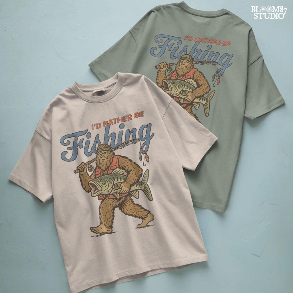 Funny vintage illustration of Bigfoot wearing a fishing vest, holding a giant bass and fishing rod, with text that reads “I’d Rather Be Fishing.”