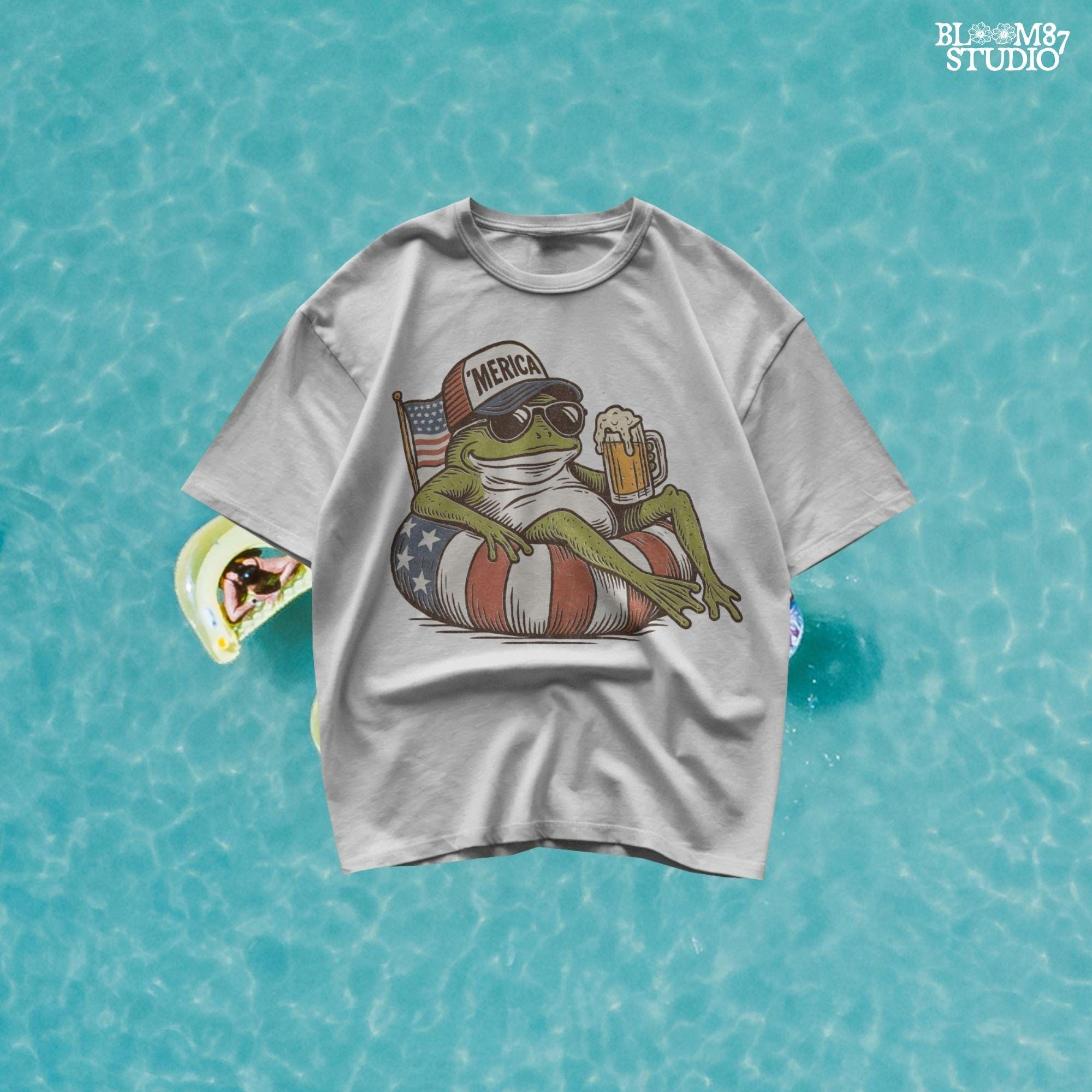 A vintage-style cartoon frog lounging on a patriotic inner tube, wearing a ‘Merica cap and sunglasses, holding a mug of beer with an American flag in the background.